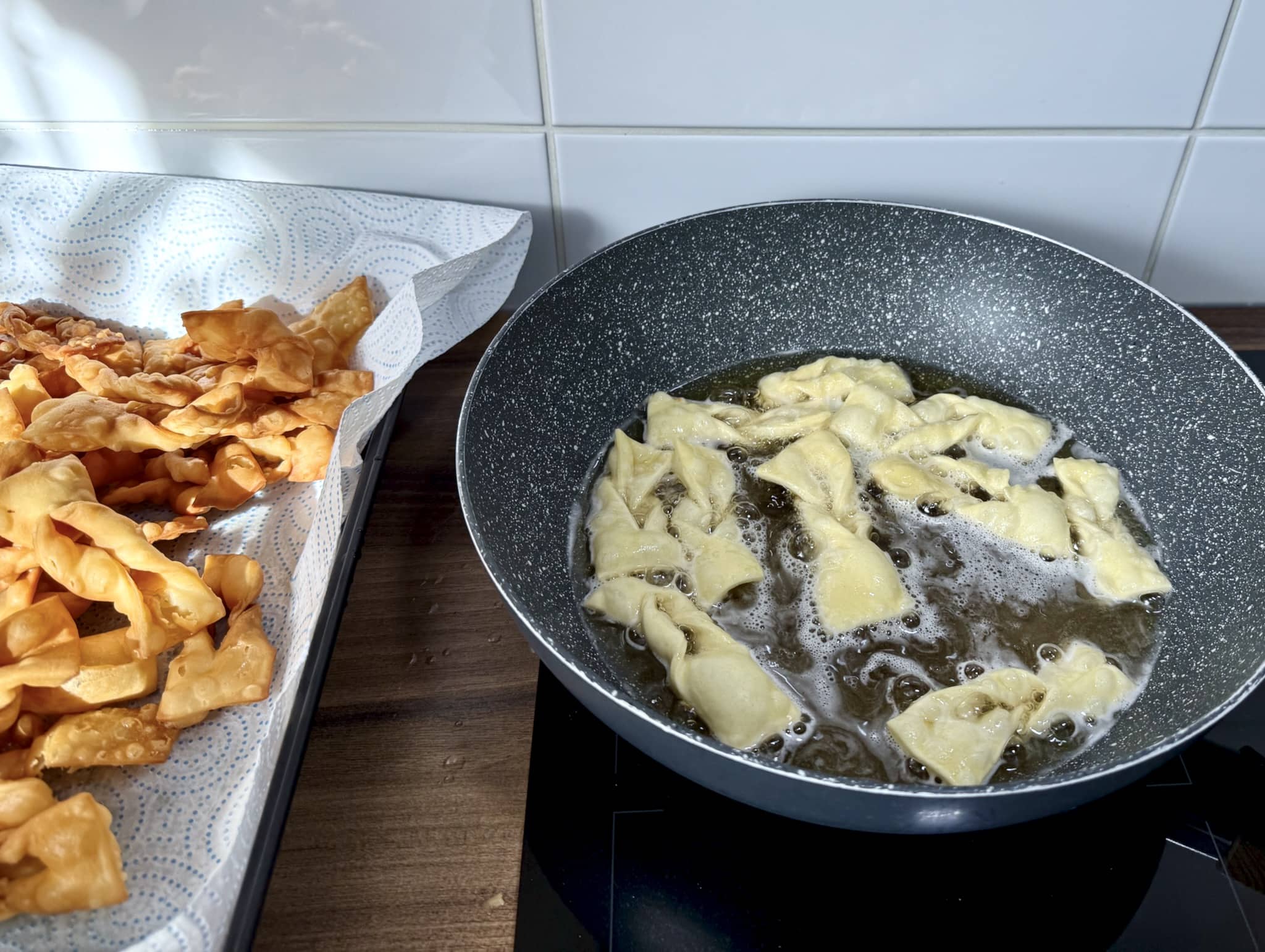 Angel wings frying in a pan