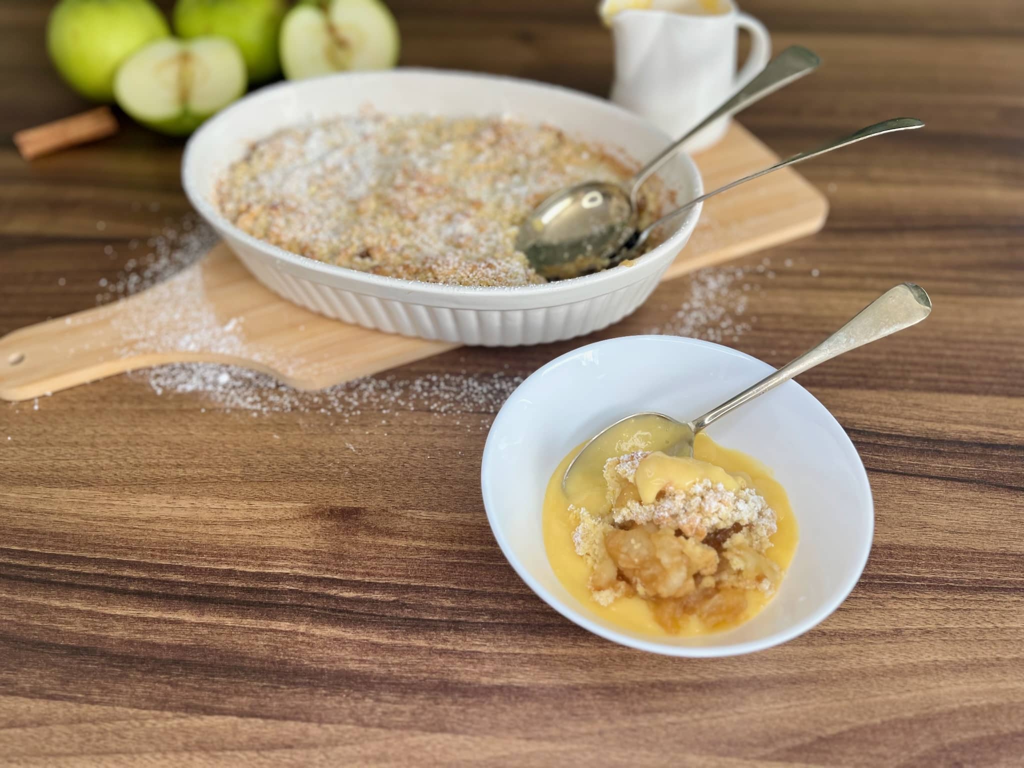 Portion of Apple Crumble with custart in a bowl