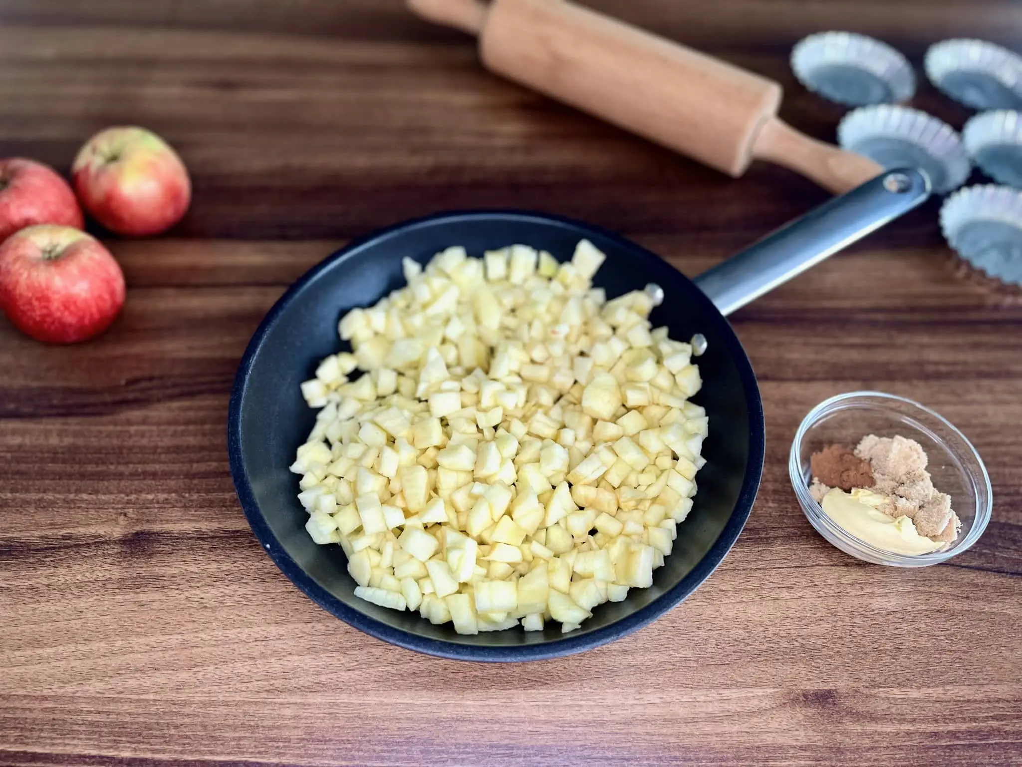 Diced apples placed in a small pot before sautéing