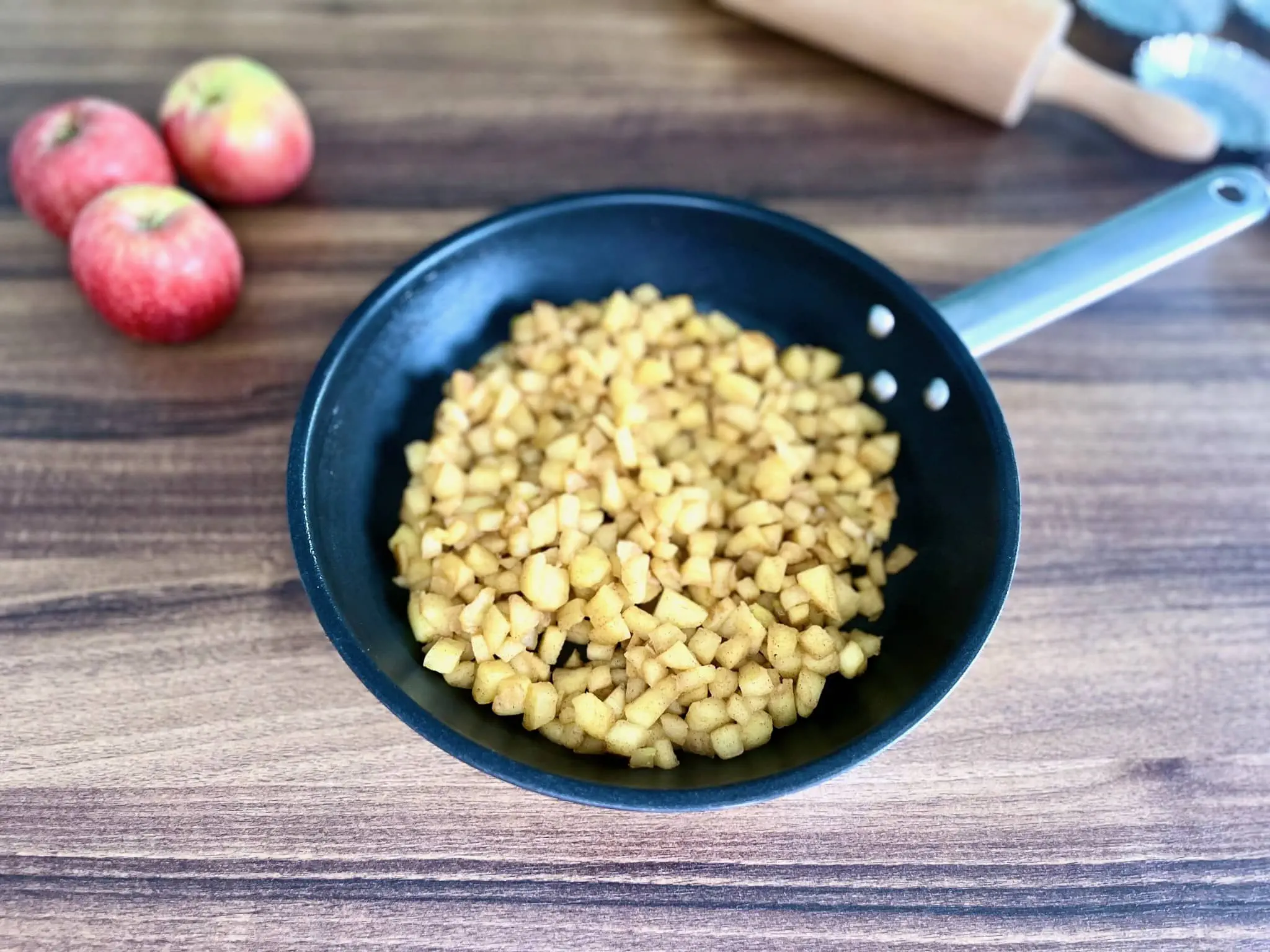 Diced apples in a small pot after sautéing.