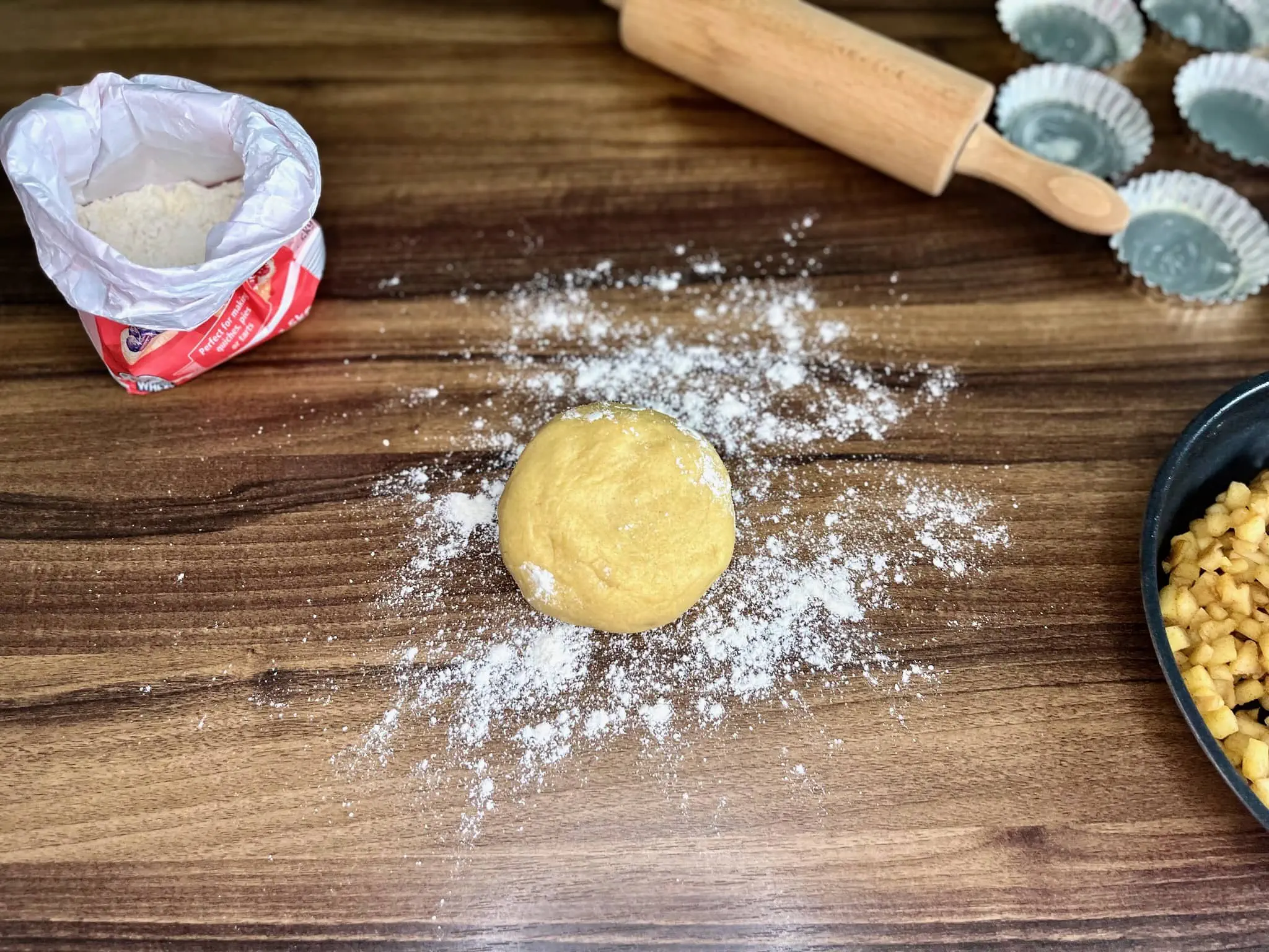 A ball of dough on a dusted tabletop after chilling in the fridge