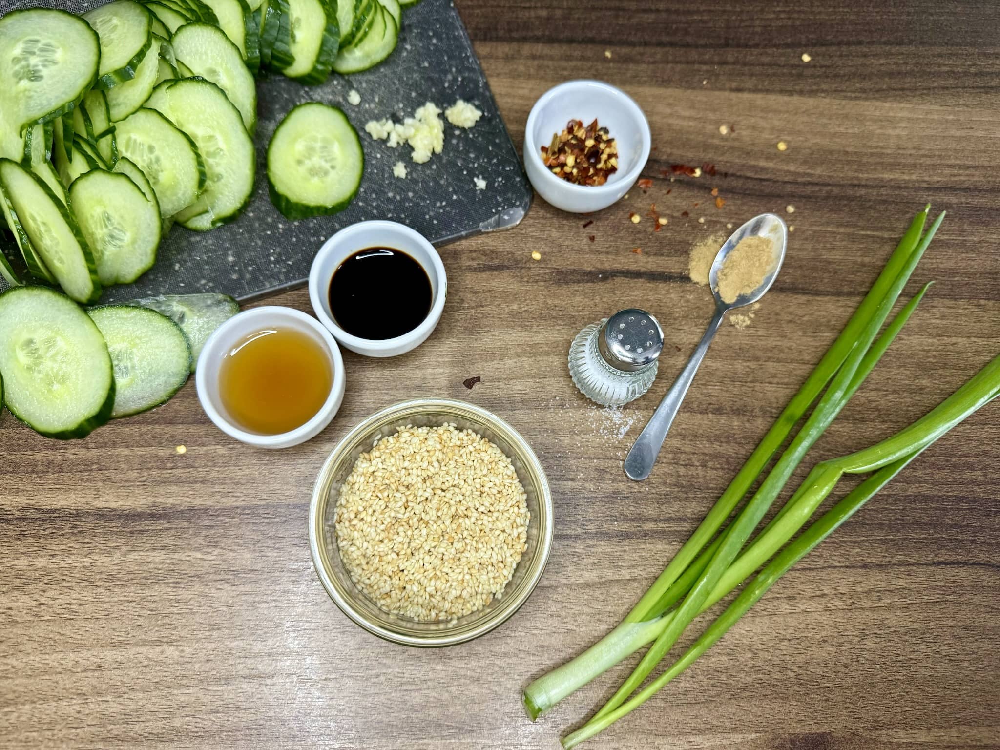 Sliced cucumber on the side with other ingredients ready to be mixed