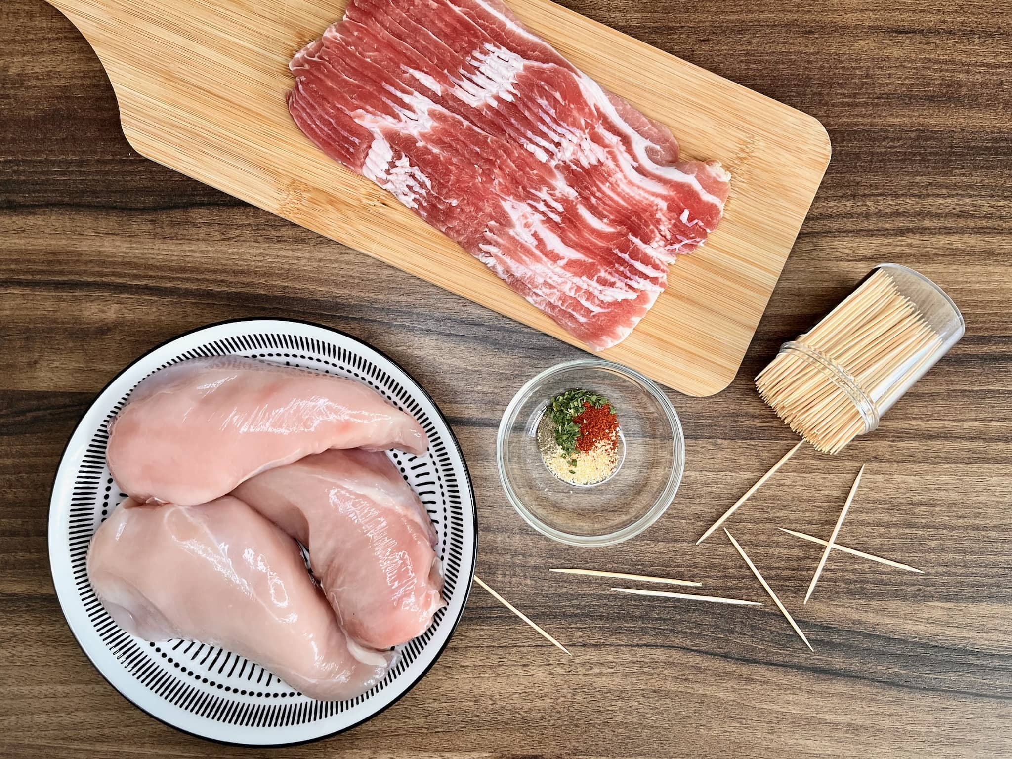 Ingredients are laid out on the tabletop, ready to prepare Bacon-Wrapped Chicken Bites