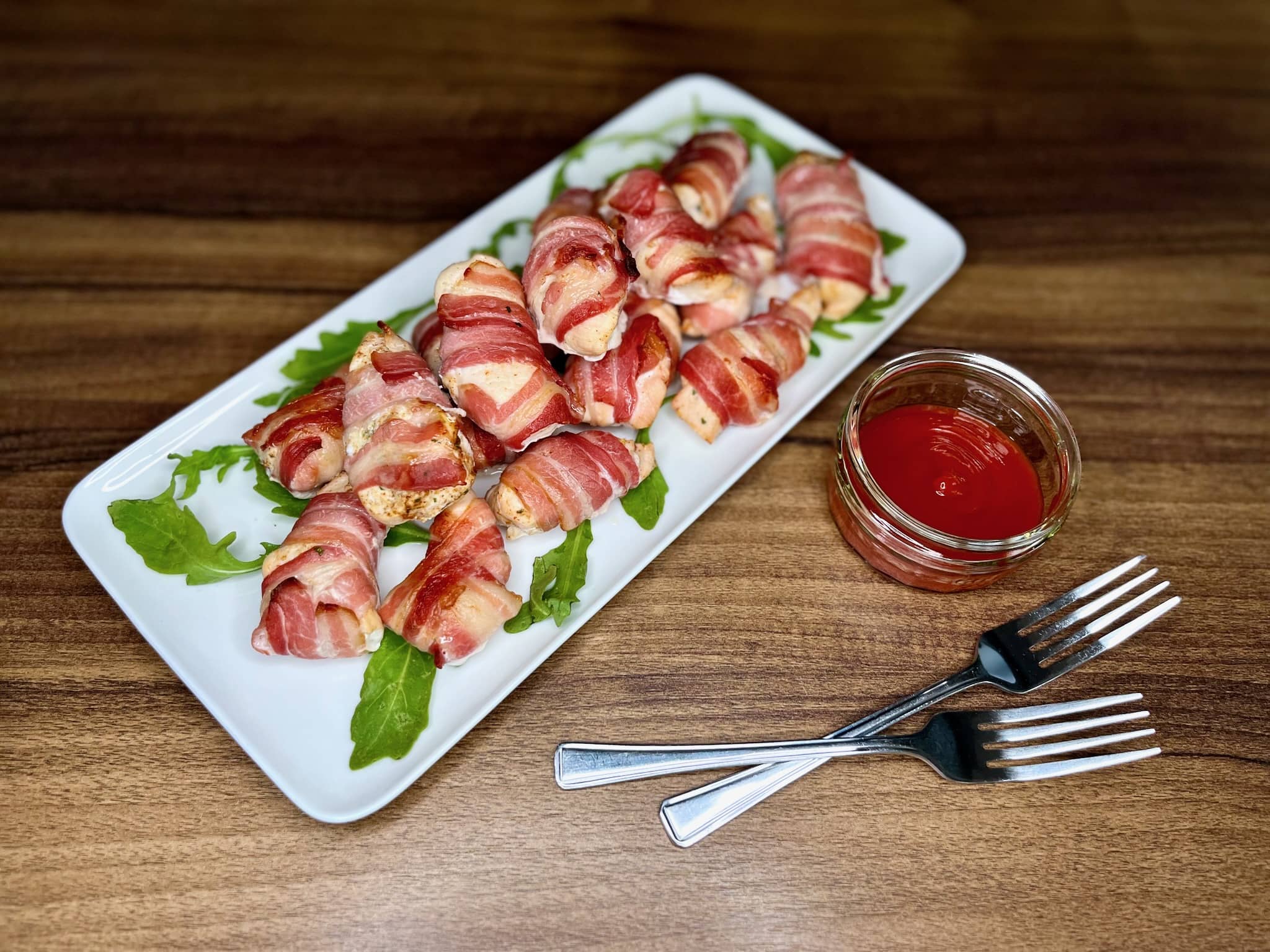 A platter of enticing Bacon-Wrapped Chicken Bites invites guests to indulge