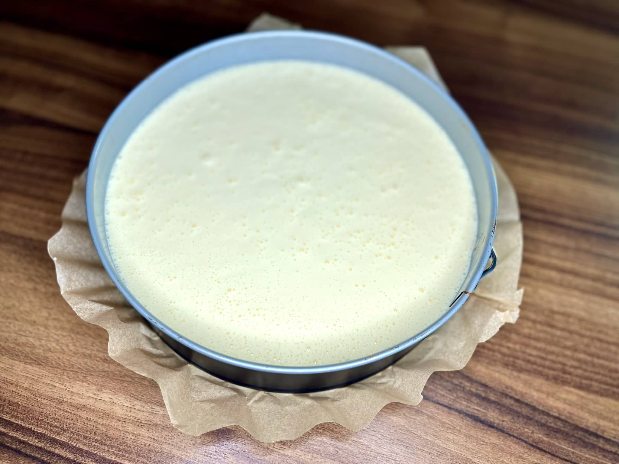 Cheesecake batter in a cake tin, ready for the oven