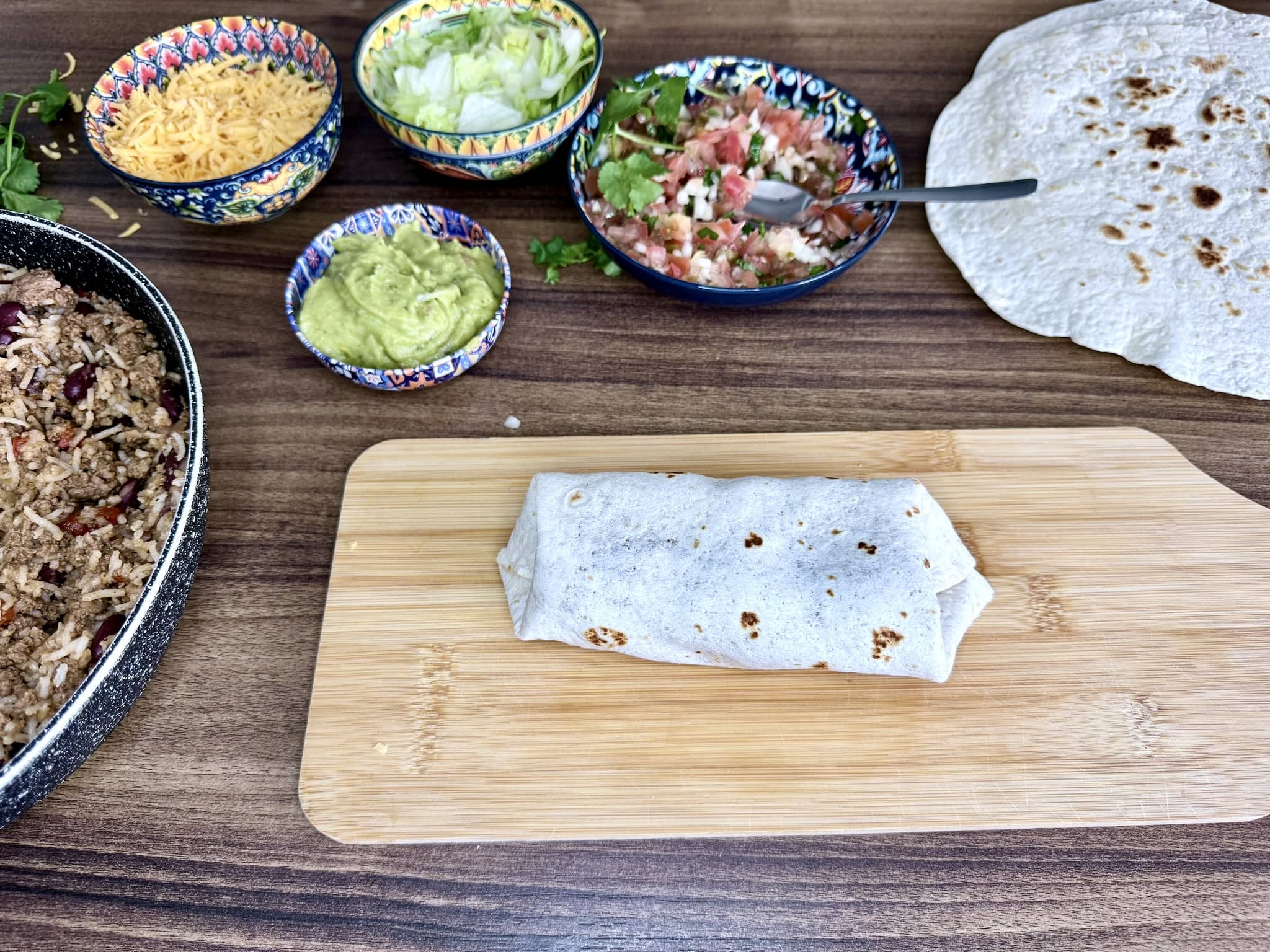 A neatly wrapped beef burrito before being cut in half