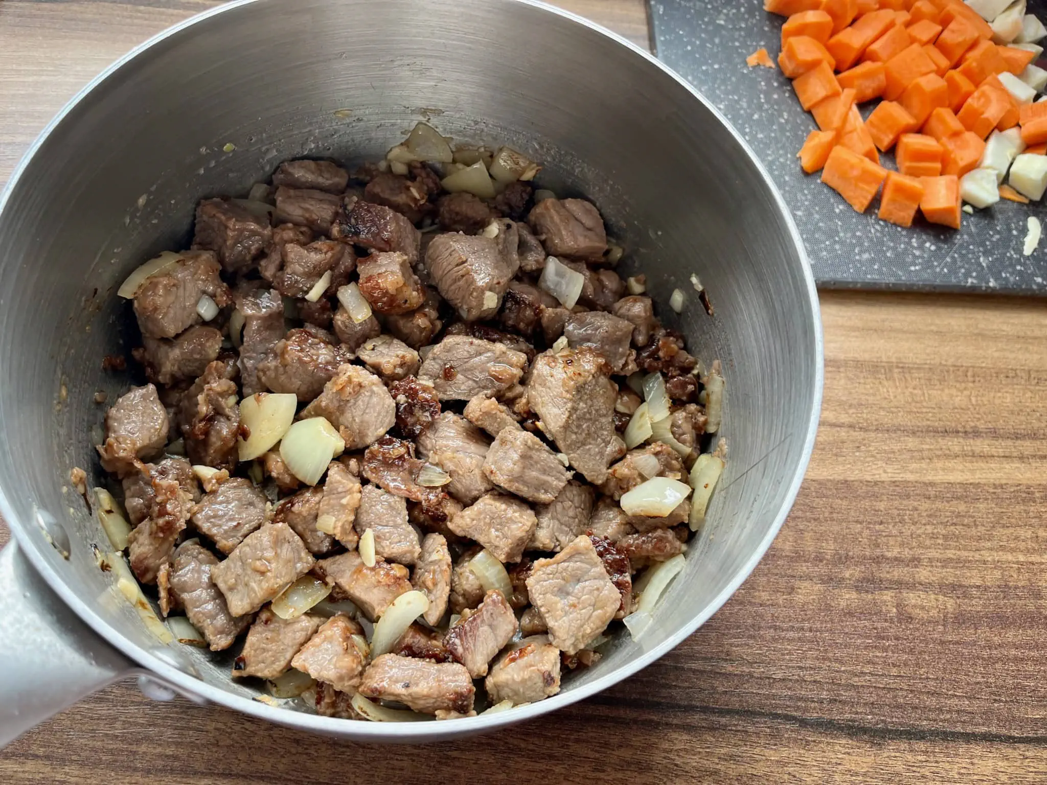Cooked beef and onion in a saucepan