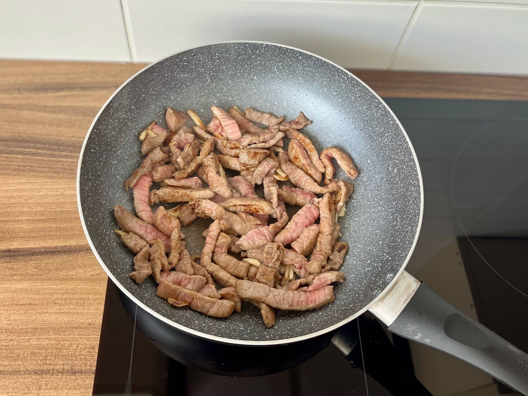 Fried beef with garlic in a pan getting brown all over