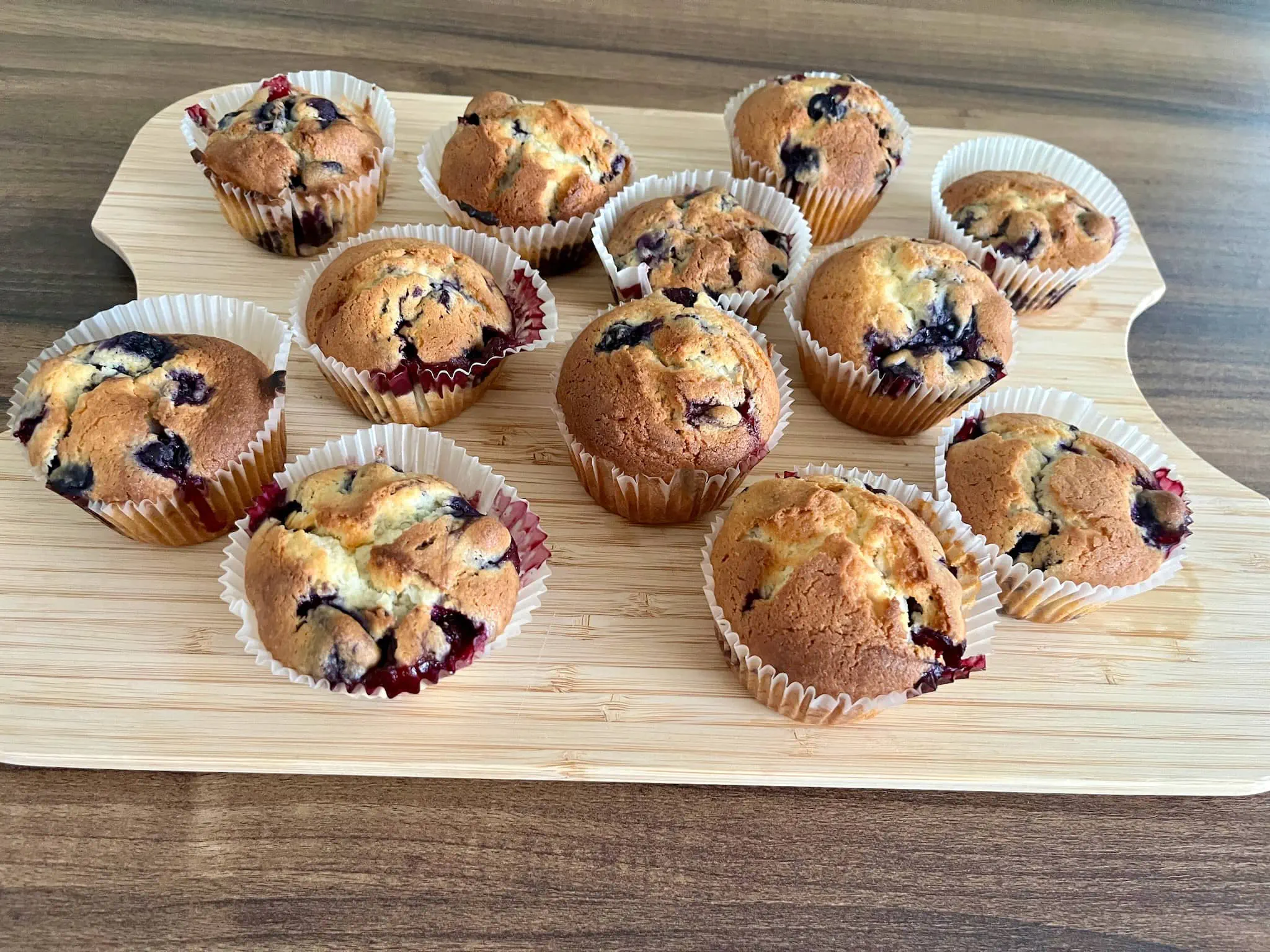 Baked blueberry muffins cooling down on the board