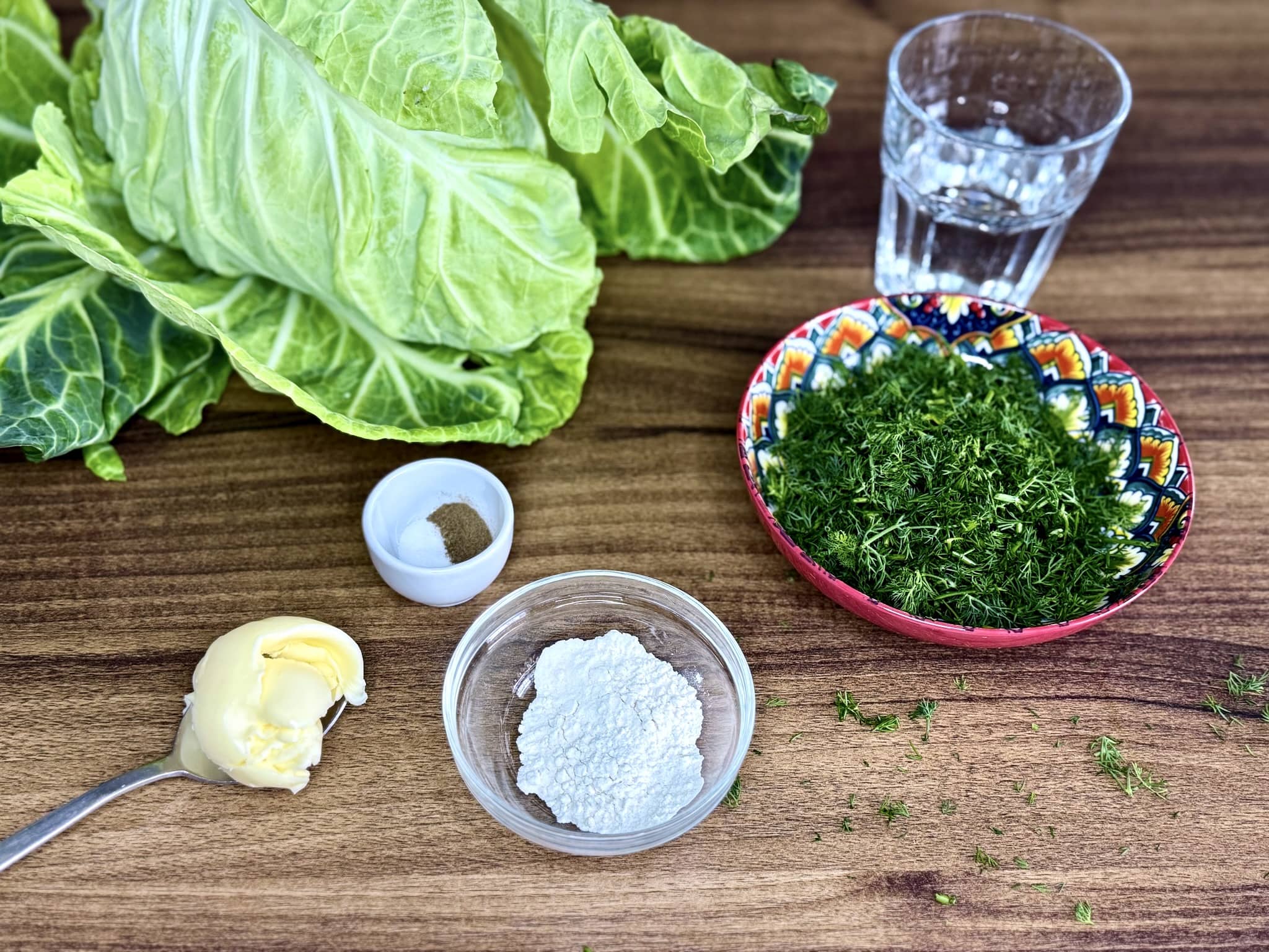 All the ingredients on a tabletop ready to make Braised Young Cabbage with Dill