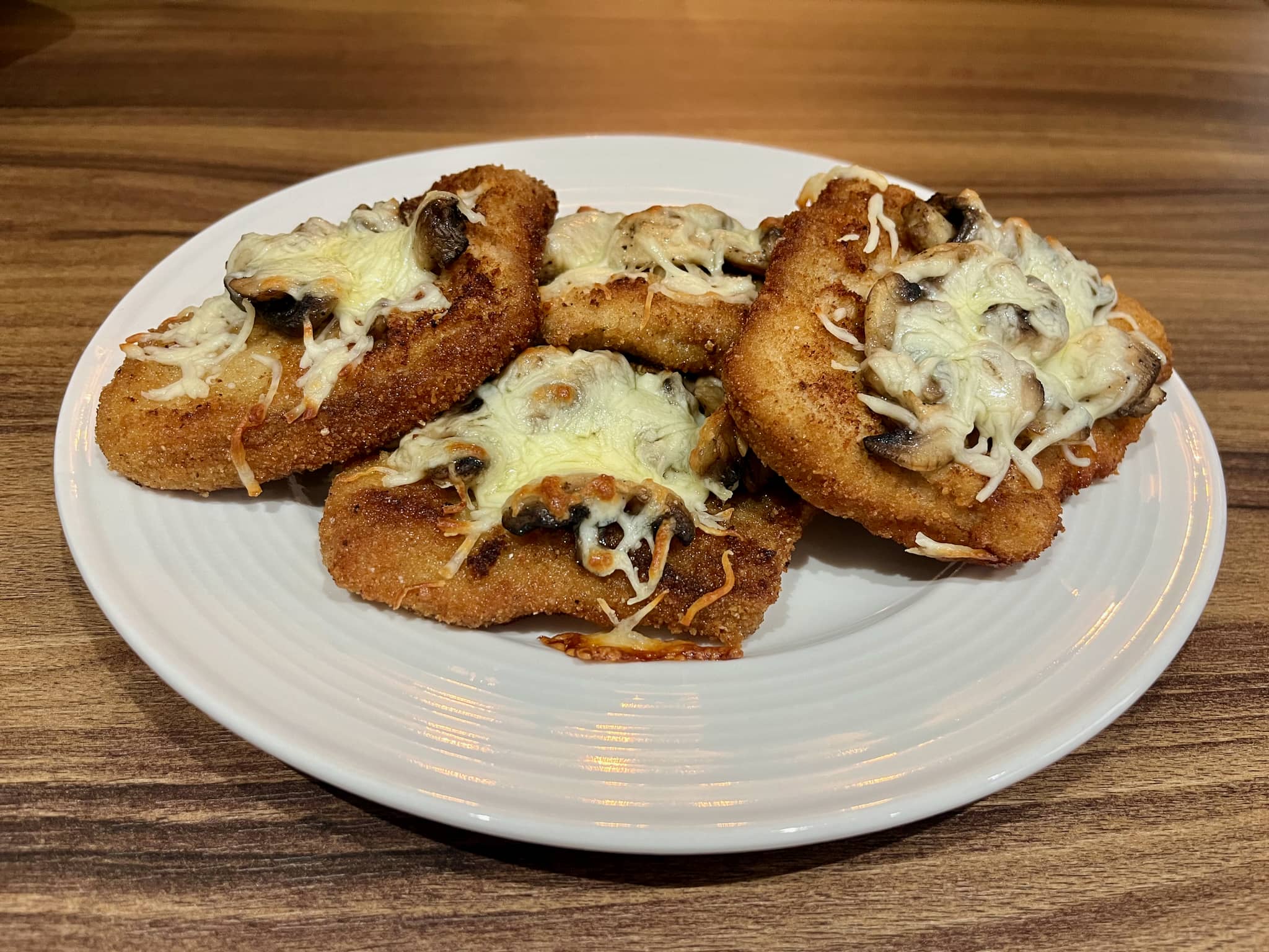 Breaded Pork Loins with Mushrooms and Grated Mozzarella