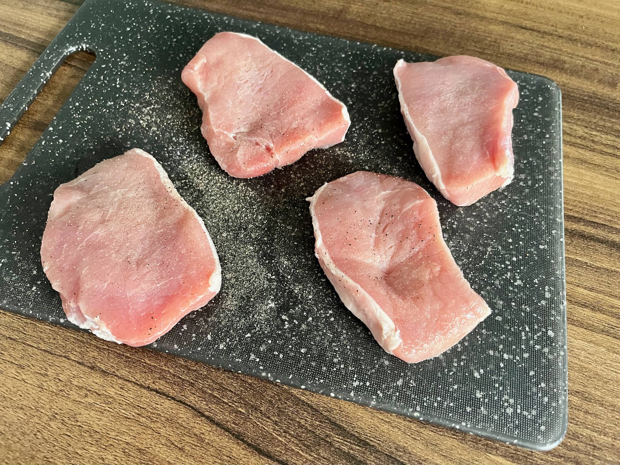 Seasoned pork loins on the chopping board
