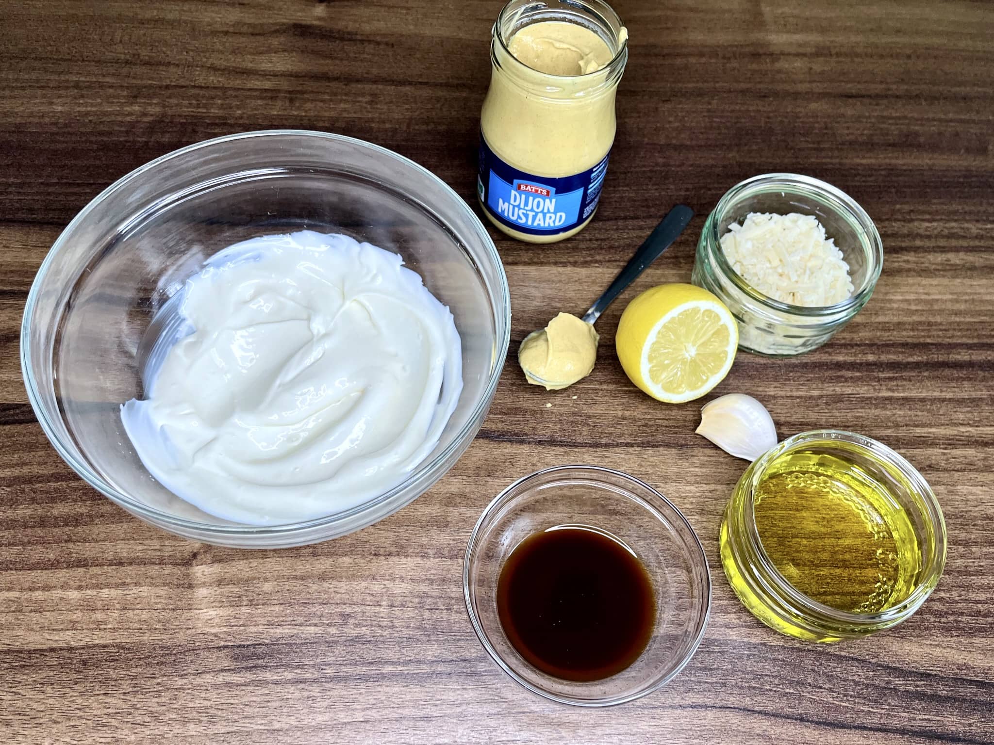 All the ingredients on the table top ready to make Caesar Salad Dressing