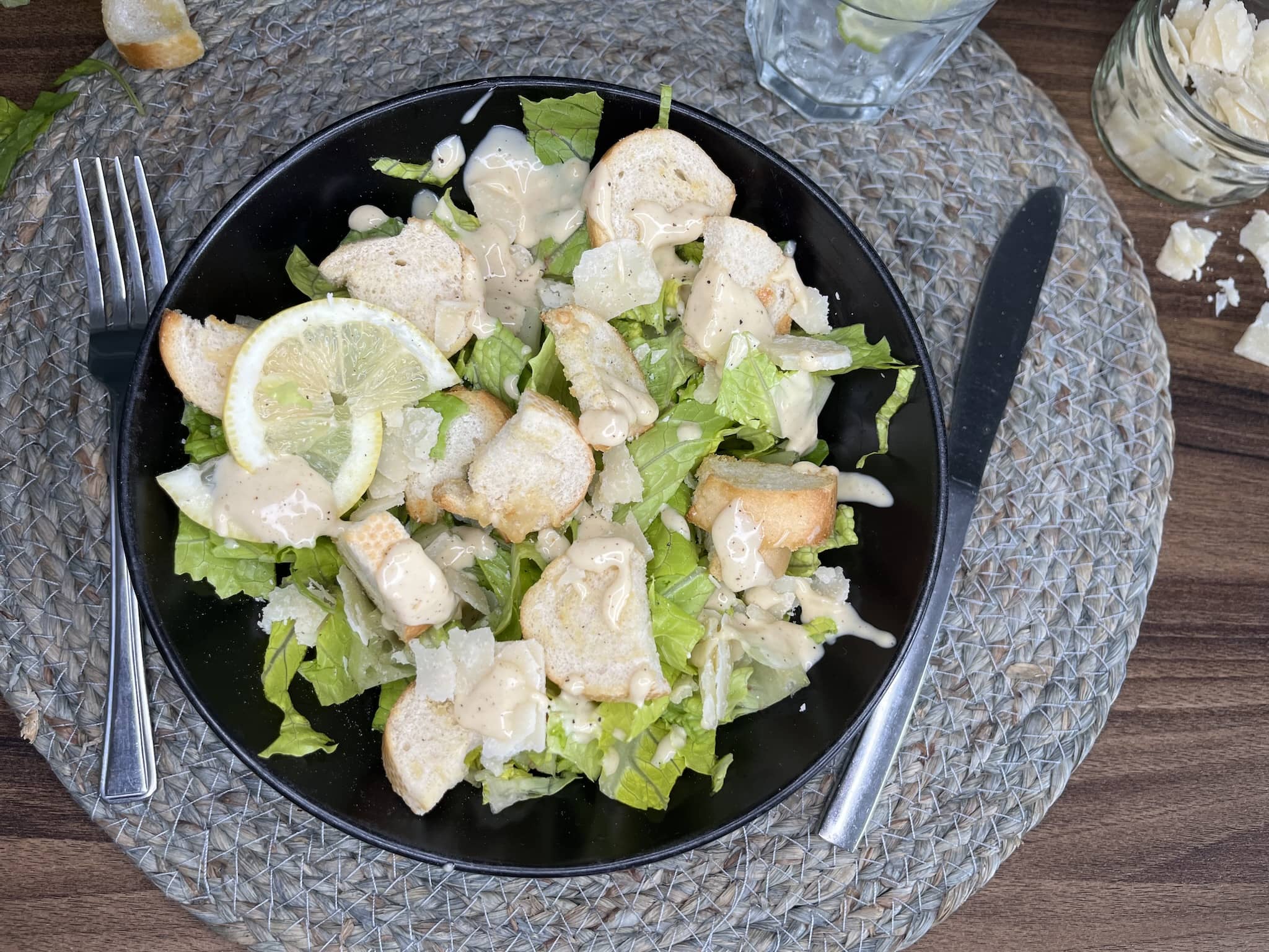 Ready-made and nicely served Caesar Salad finished with a slice of lemon on top