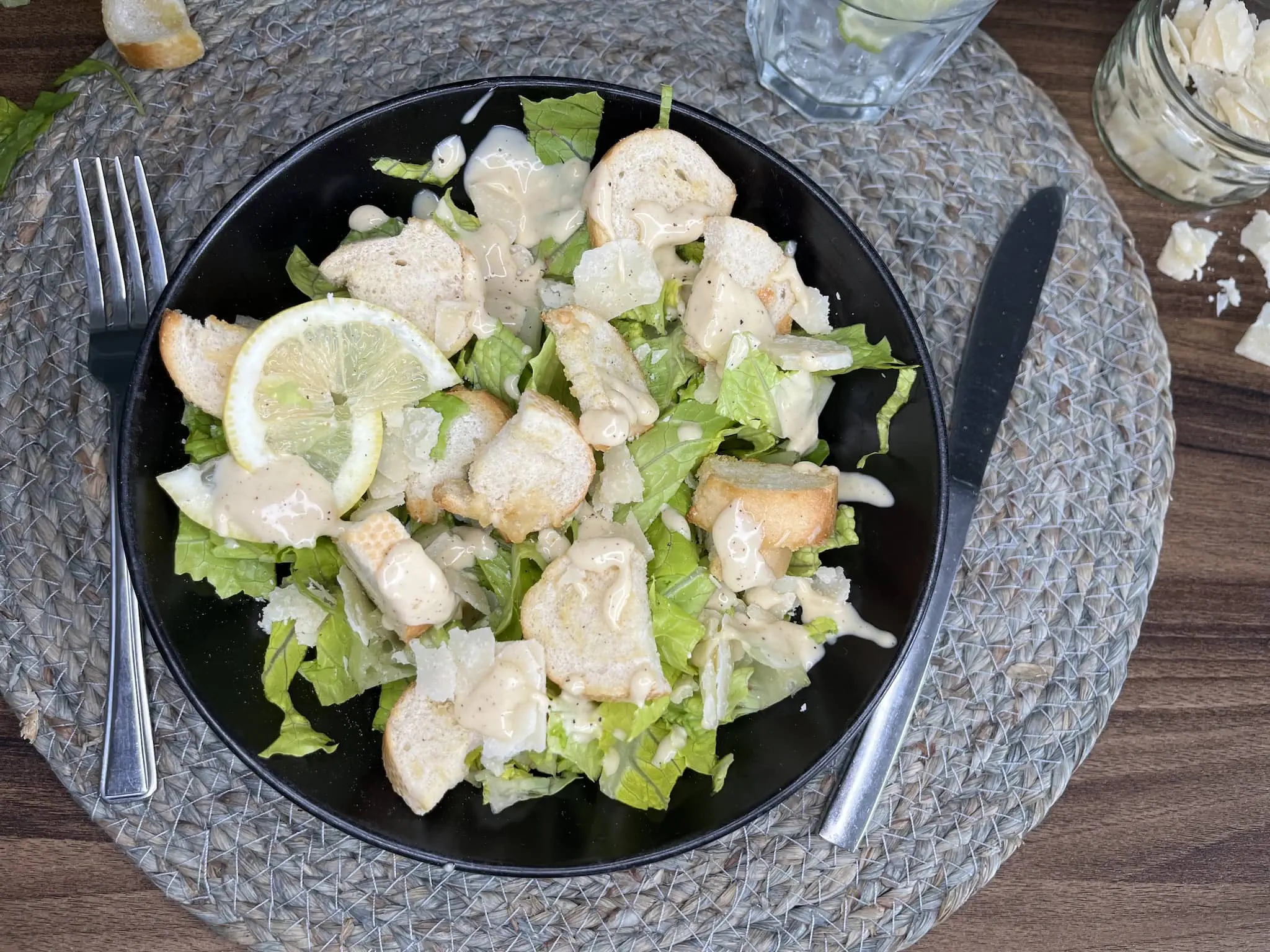 Ready-made and nicely served Caesar Salad finished with a slice of lemon on top