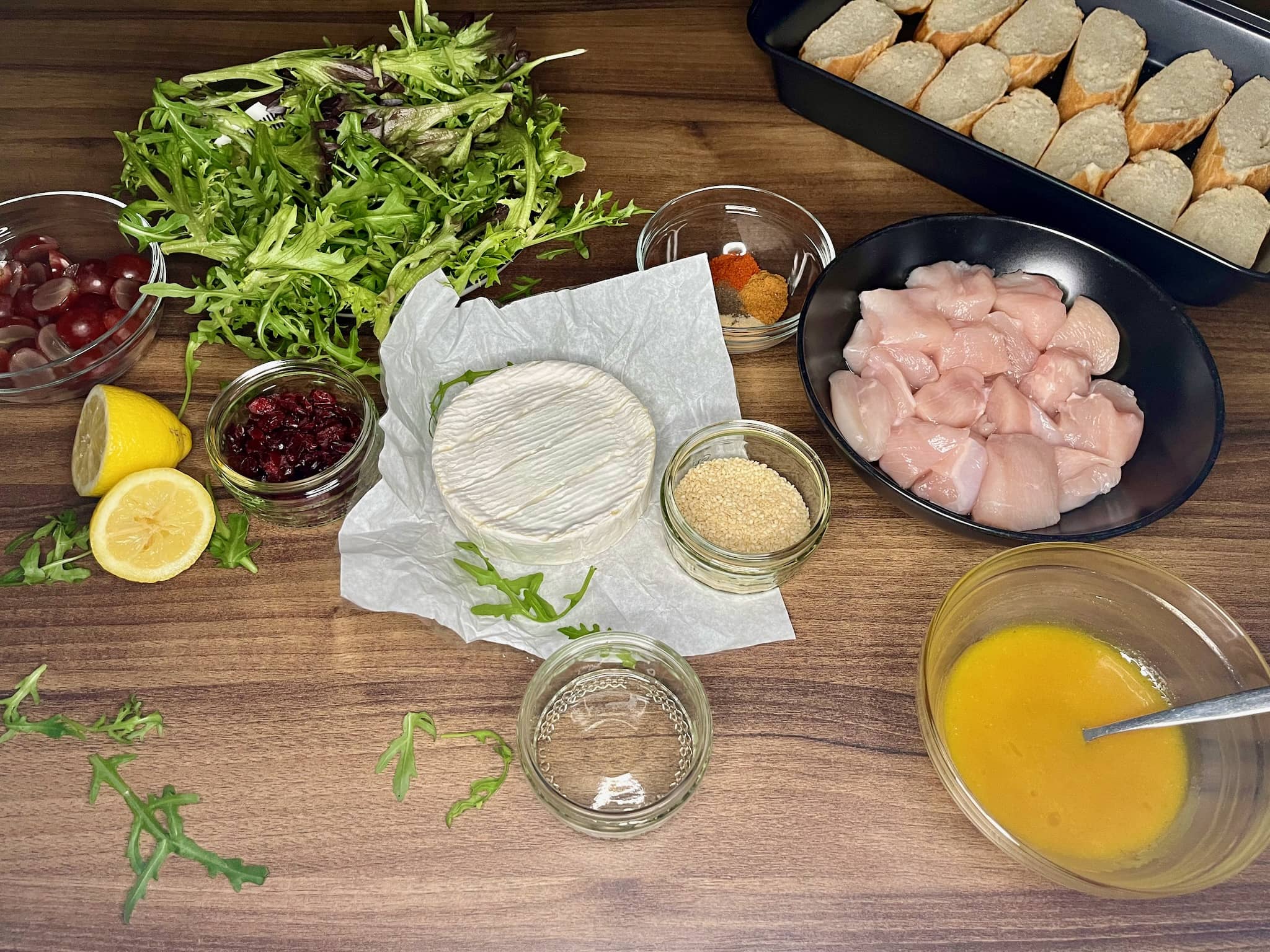 All the ingredients on a tabletop are ready to make Camembert Chicken Salad