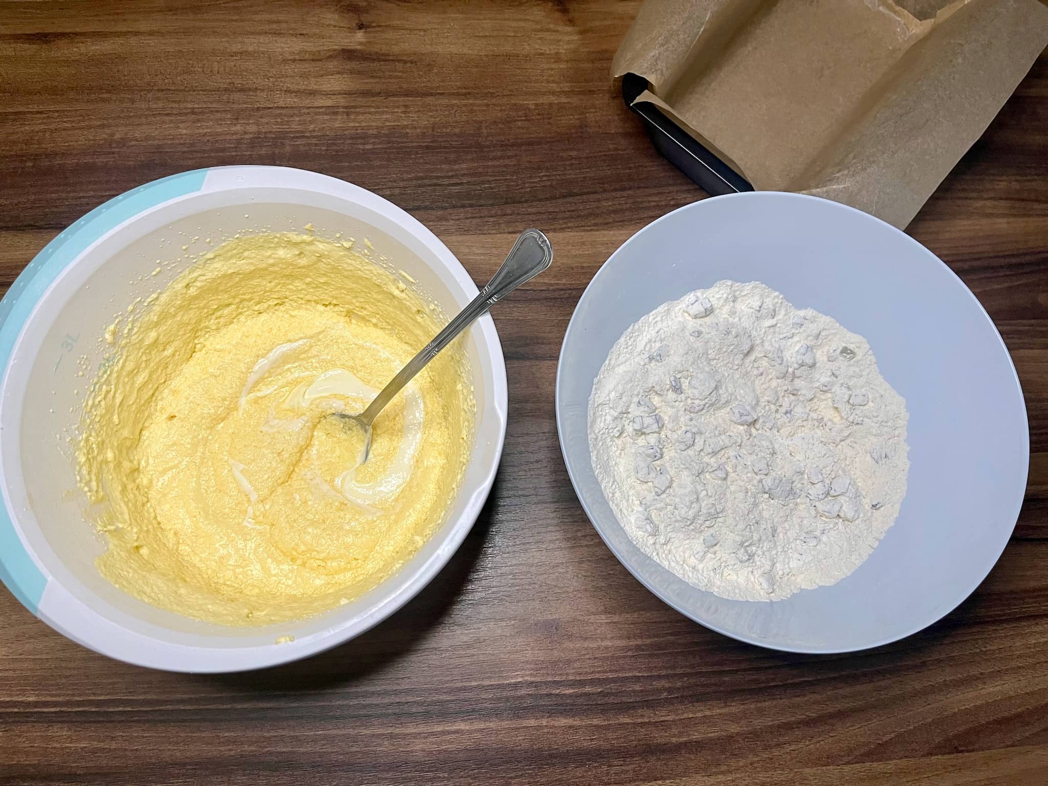 Two bowls, one with wet dough and the other with dry ingredients