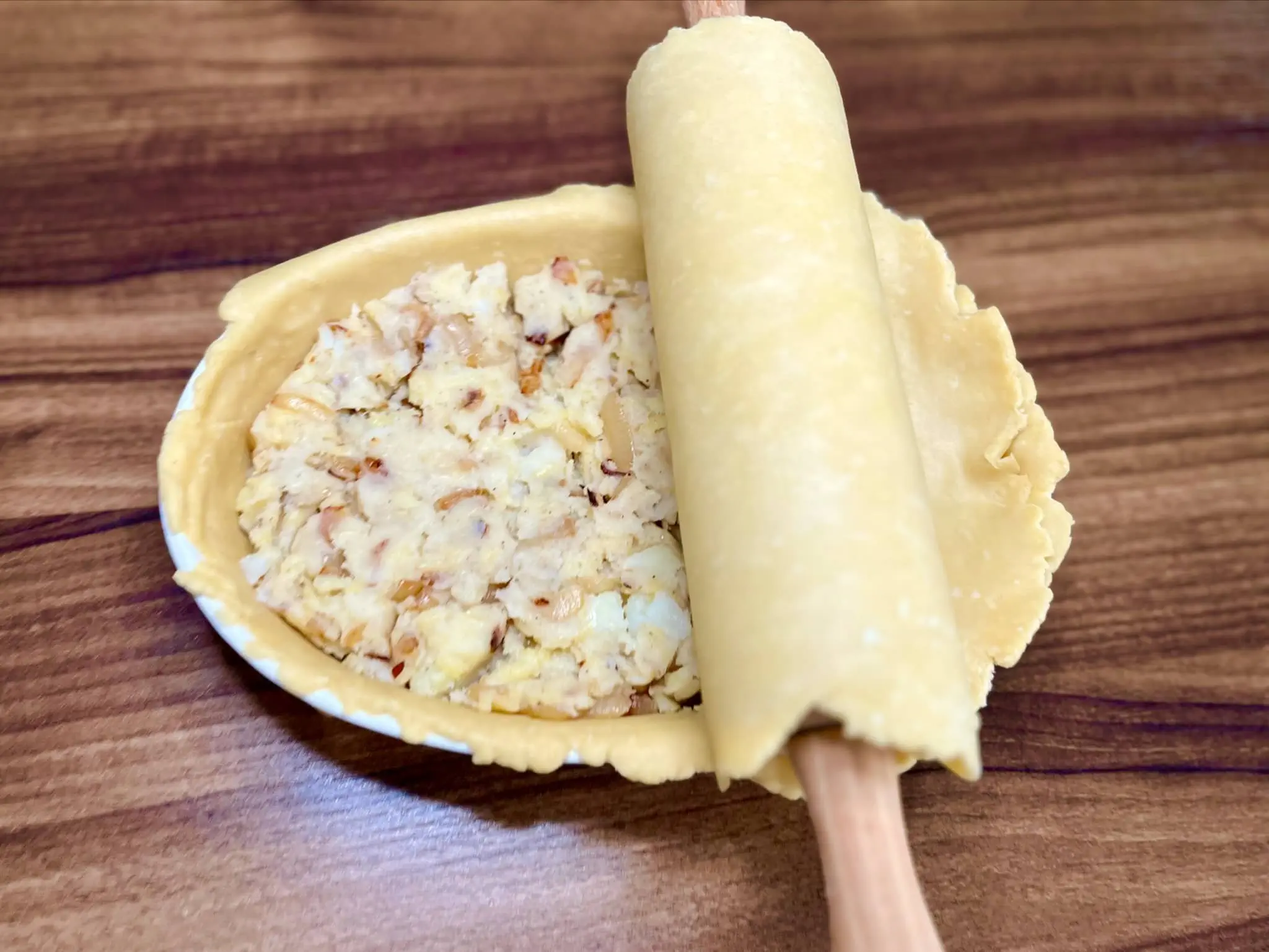 Covering the dish with a second layer of pie crust