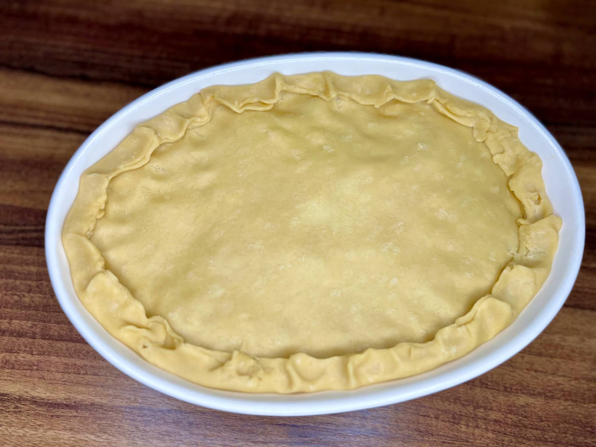 The top layer of a pie is nicely trimmed and closed on the edges