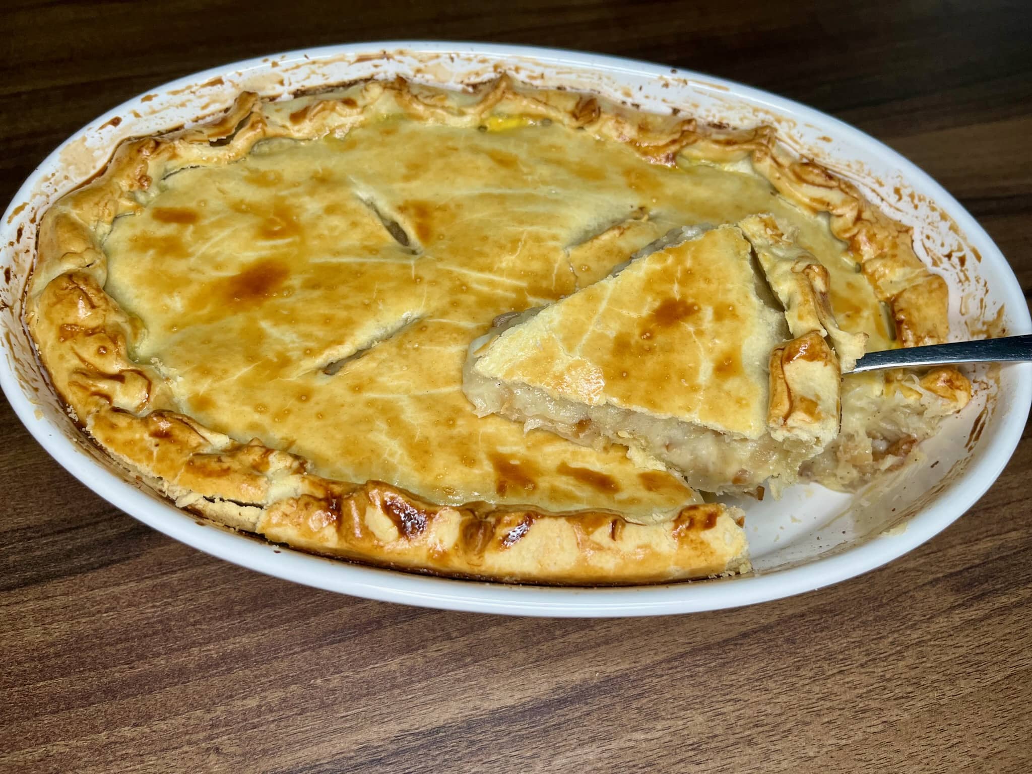 Baked Cheese and Onion pie with a slice on a fork