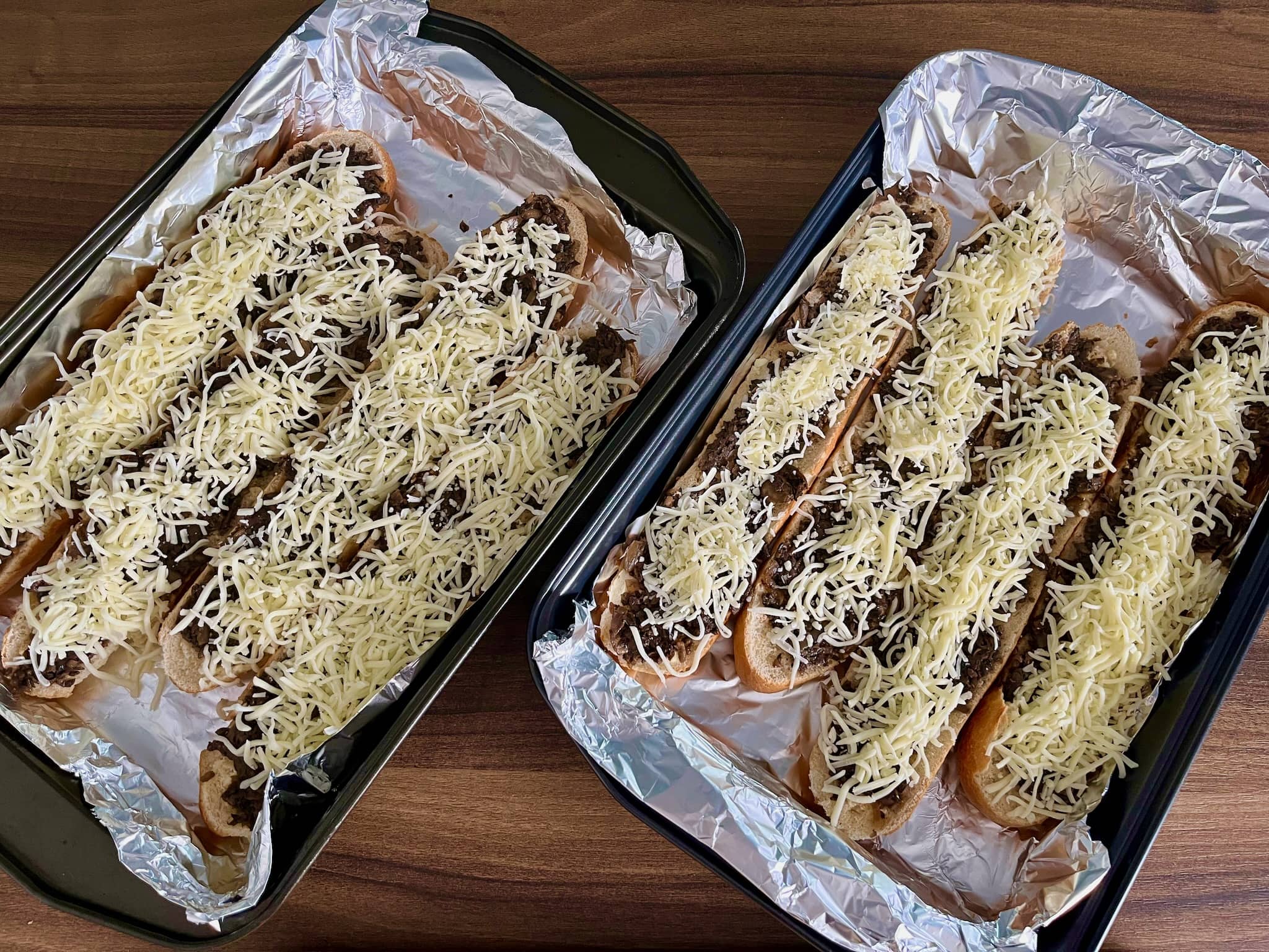 Baguettes with mushrooms sprinkled with cheese ready to bake