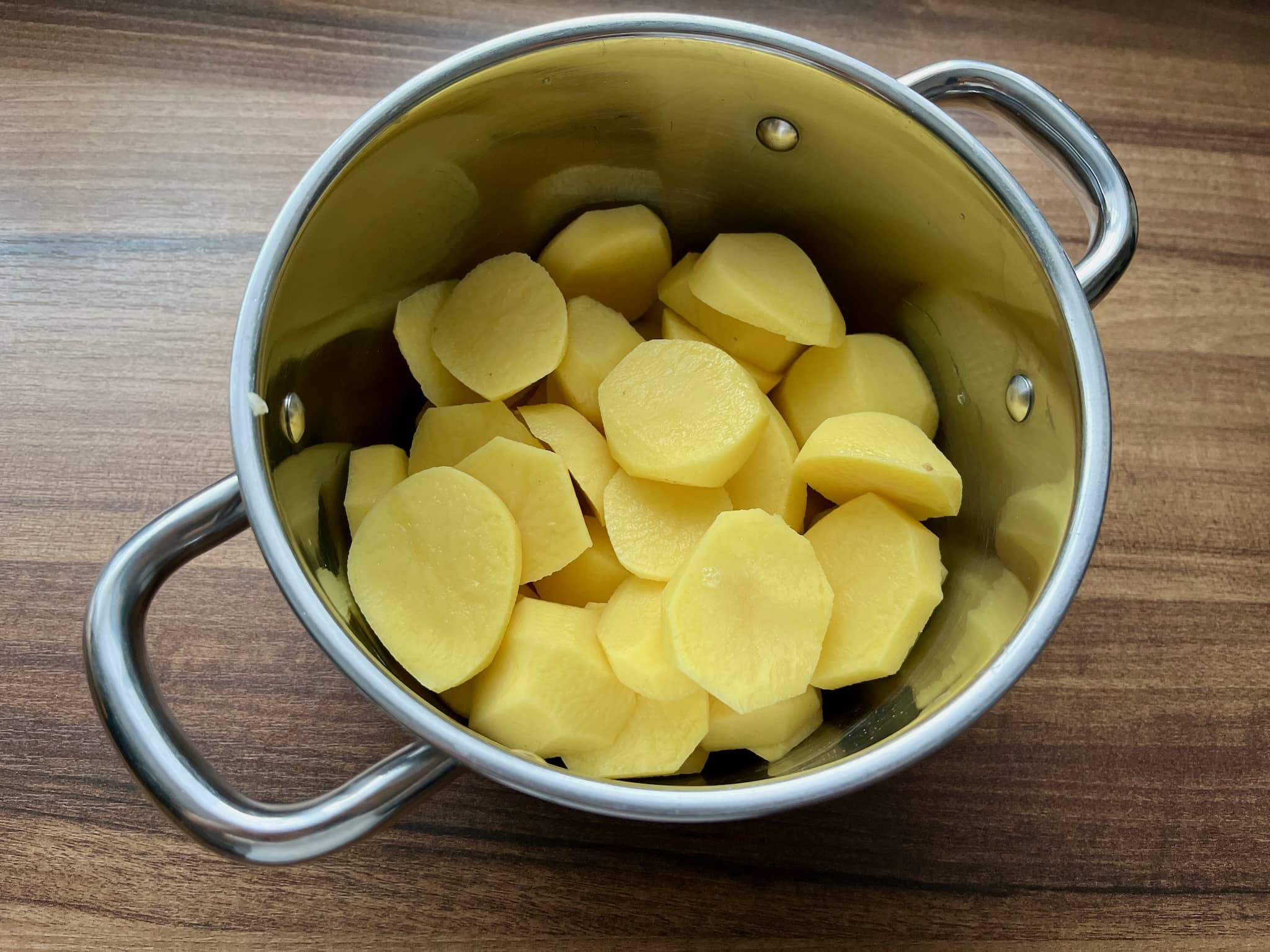 Potatoes slices in a pan before cooking