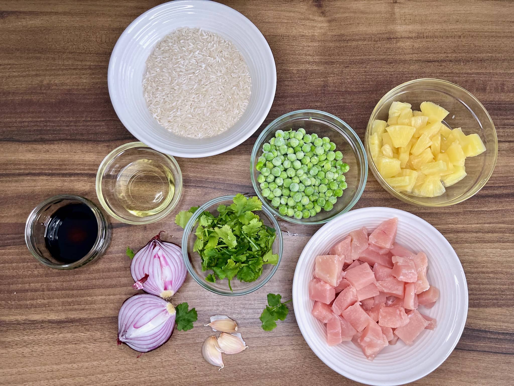 All the ingredients are on the tabletop, ready to be used to make Chicken and Pineapple Fried Rice