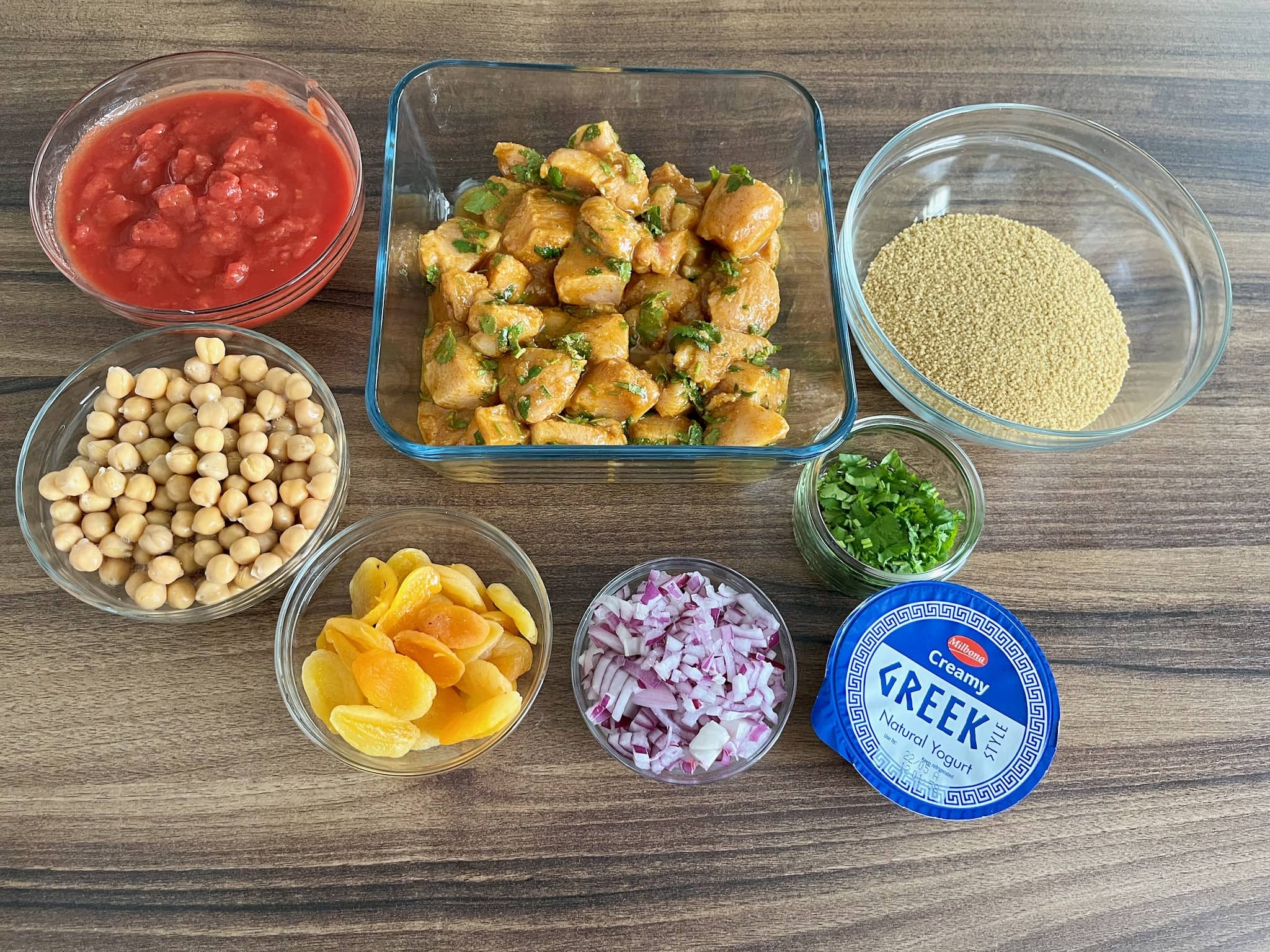 Chopped tomatoes, chicken, couscous, chickpeas, apricots, onion, coriander, greek style yoghurt