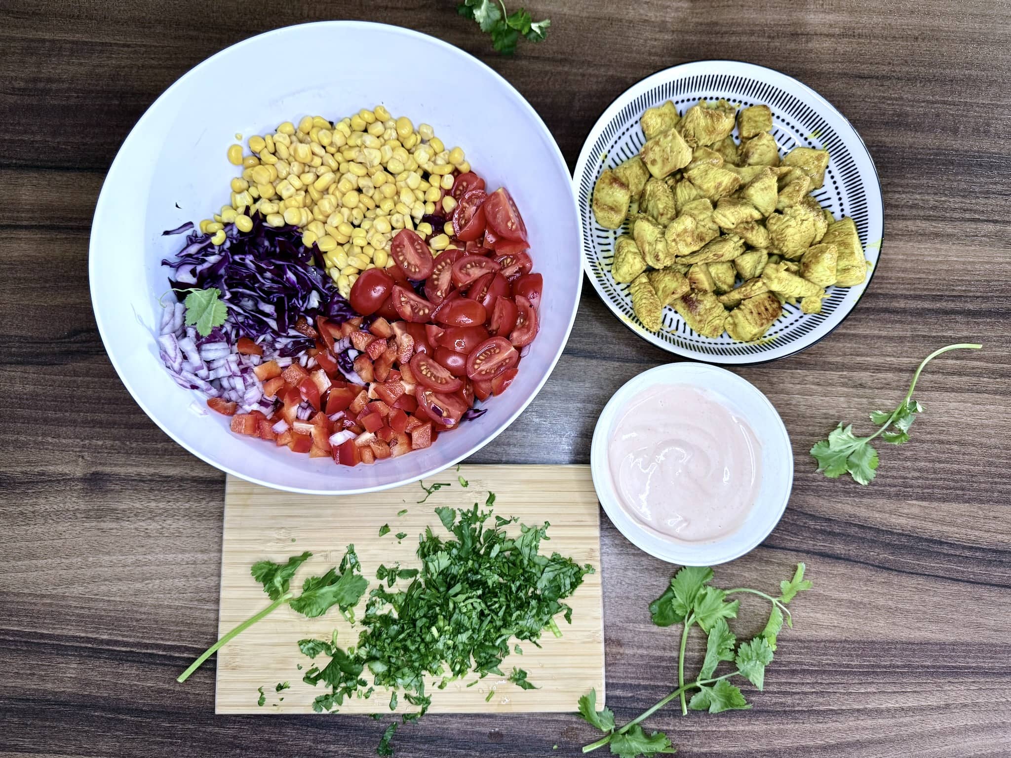All ingredients on a tabletop ready to combine into a salad