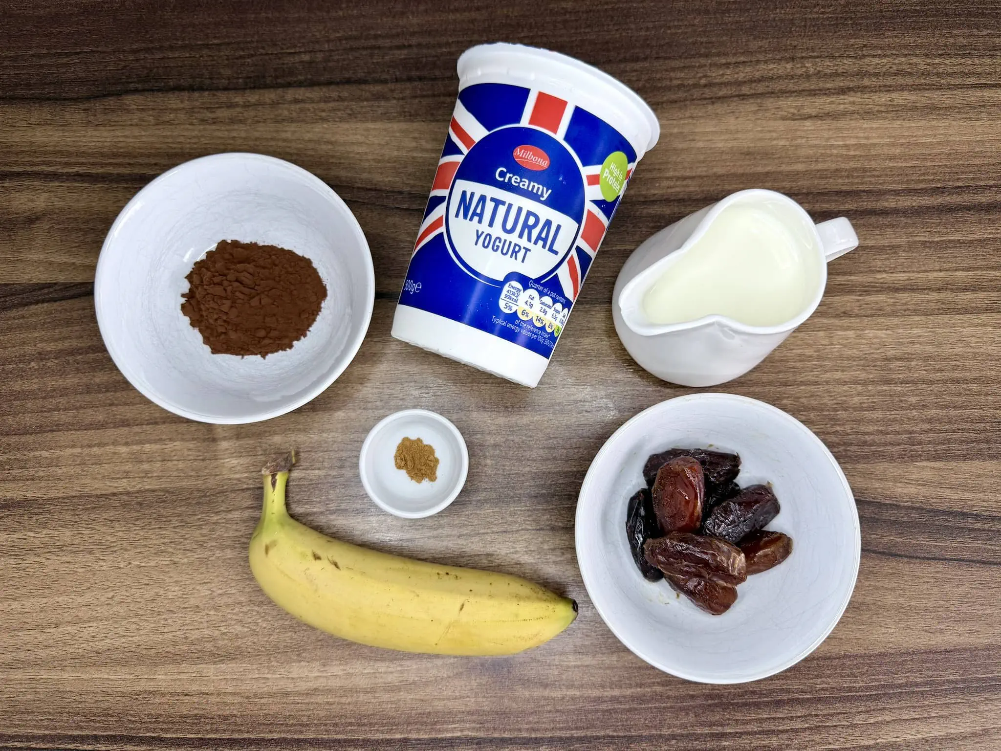 Ingredients spread out on a tabletop, ready to make Choco-Date Energy Smoothie