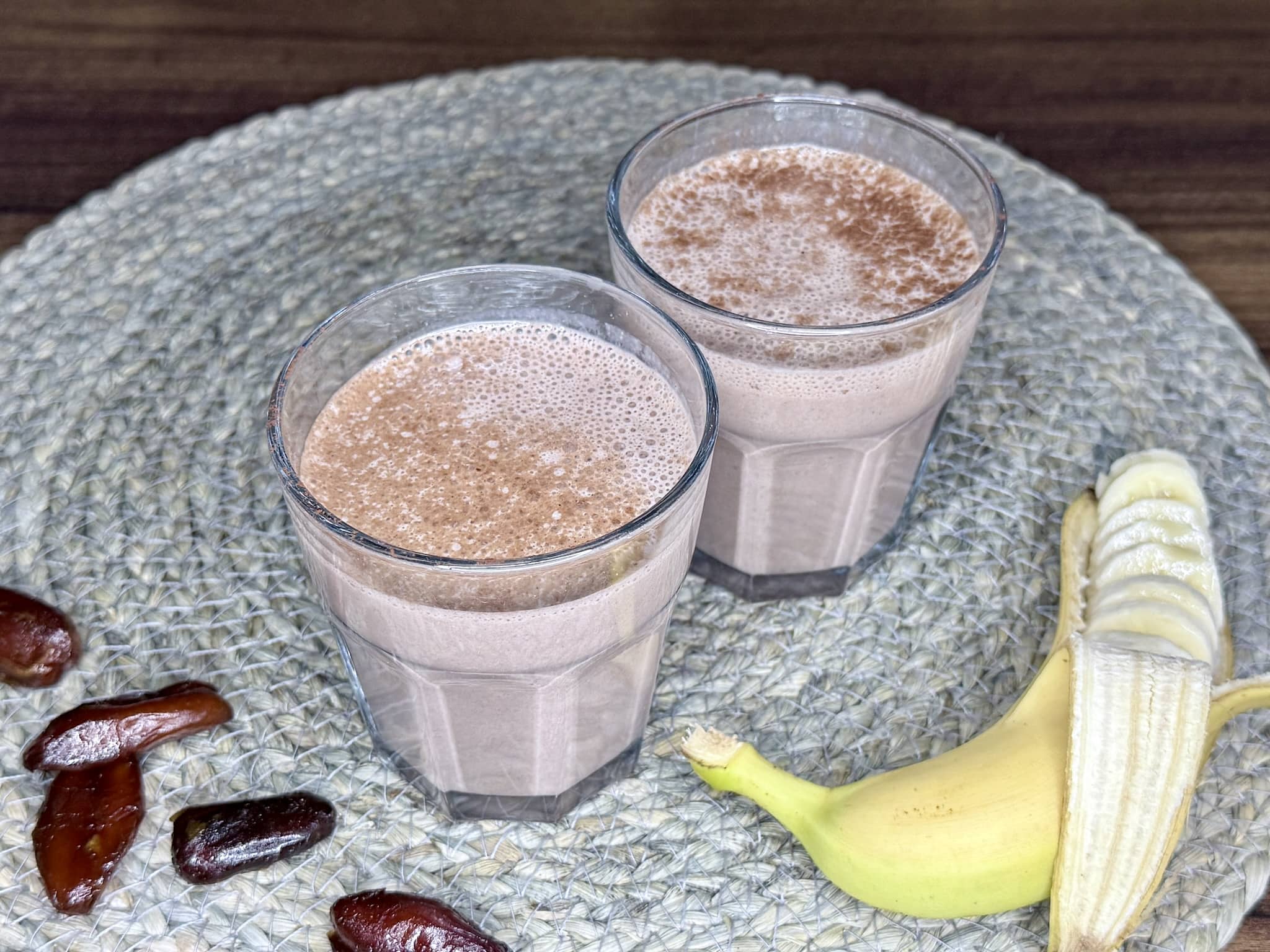 Ready Choco-Date Energy Smoothie in a glasses, dusted with cocoa powder