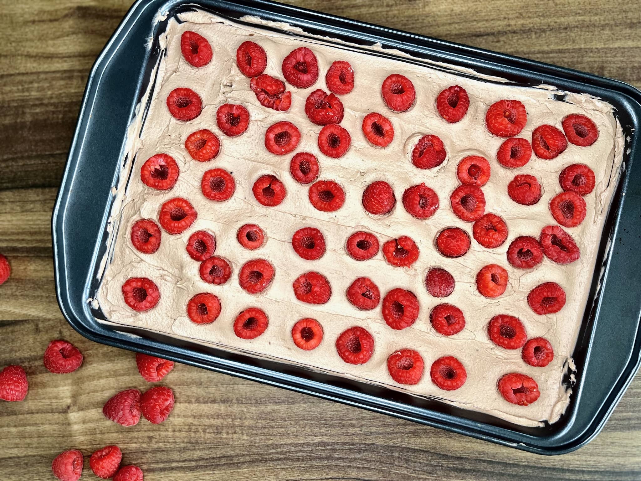Raspberries arranged on top of the cake