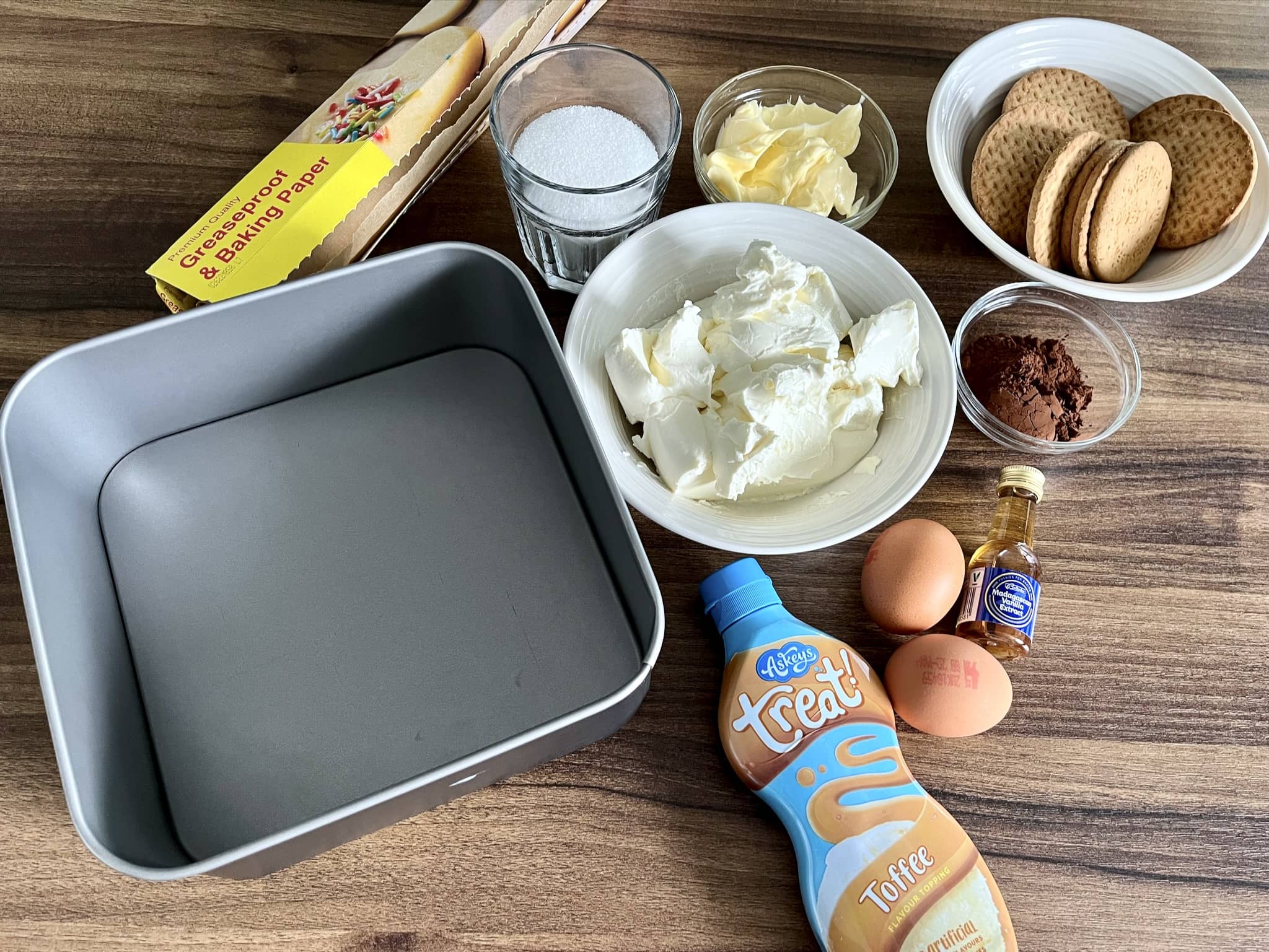 All ingredients on the tabletop ready to make Cocoa & Toffee Cheesecake