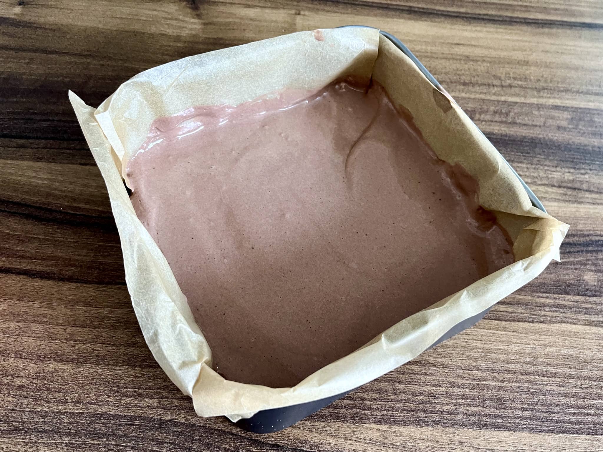 Cheesecake mixture poured on top of the butter-biscuit base