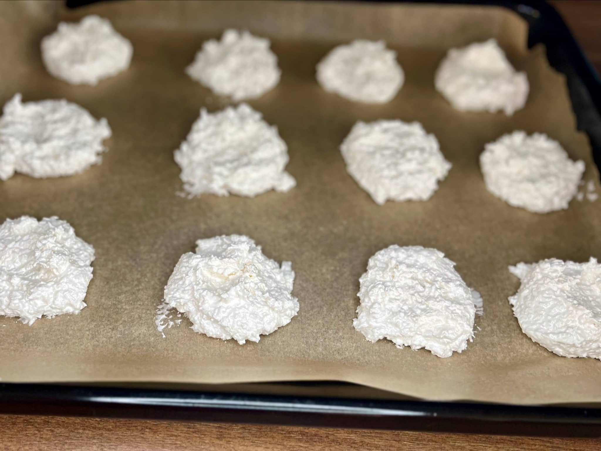 Coconut meringue cookies on a baking sheet, ready to bake