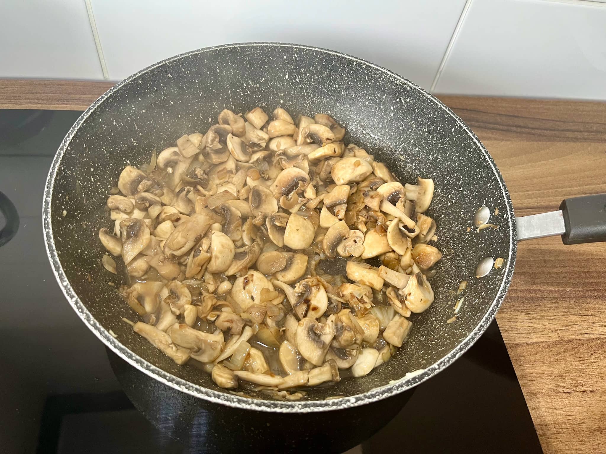 Mushrooms sizzling in a pan