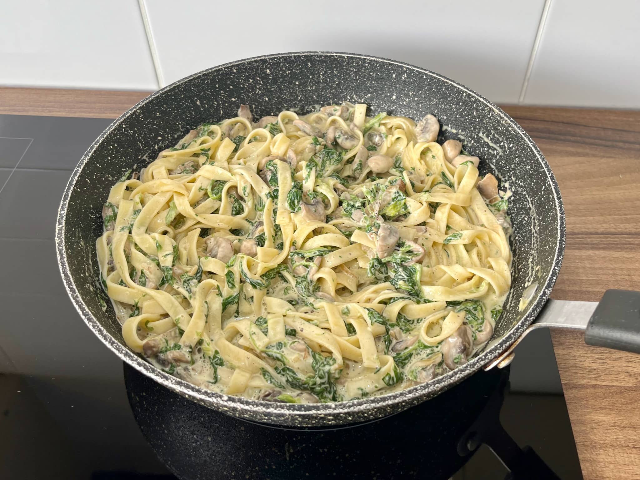 Ready Creamy Mushroom and Spinach Tagliatelle in a pan