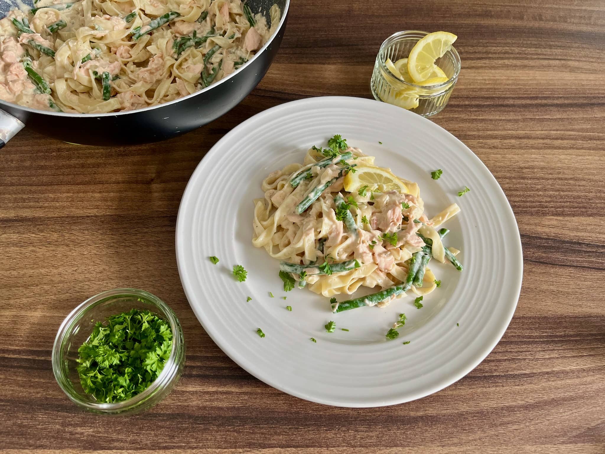 Salmon tagliatelle with a slice of lemon and scatter over with fresh parsley