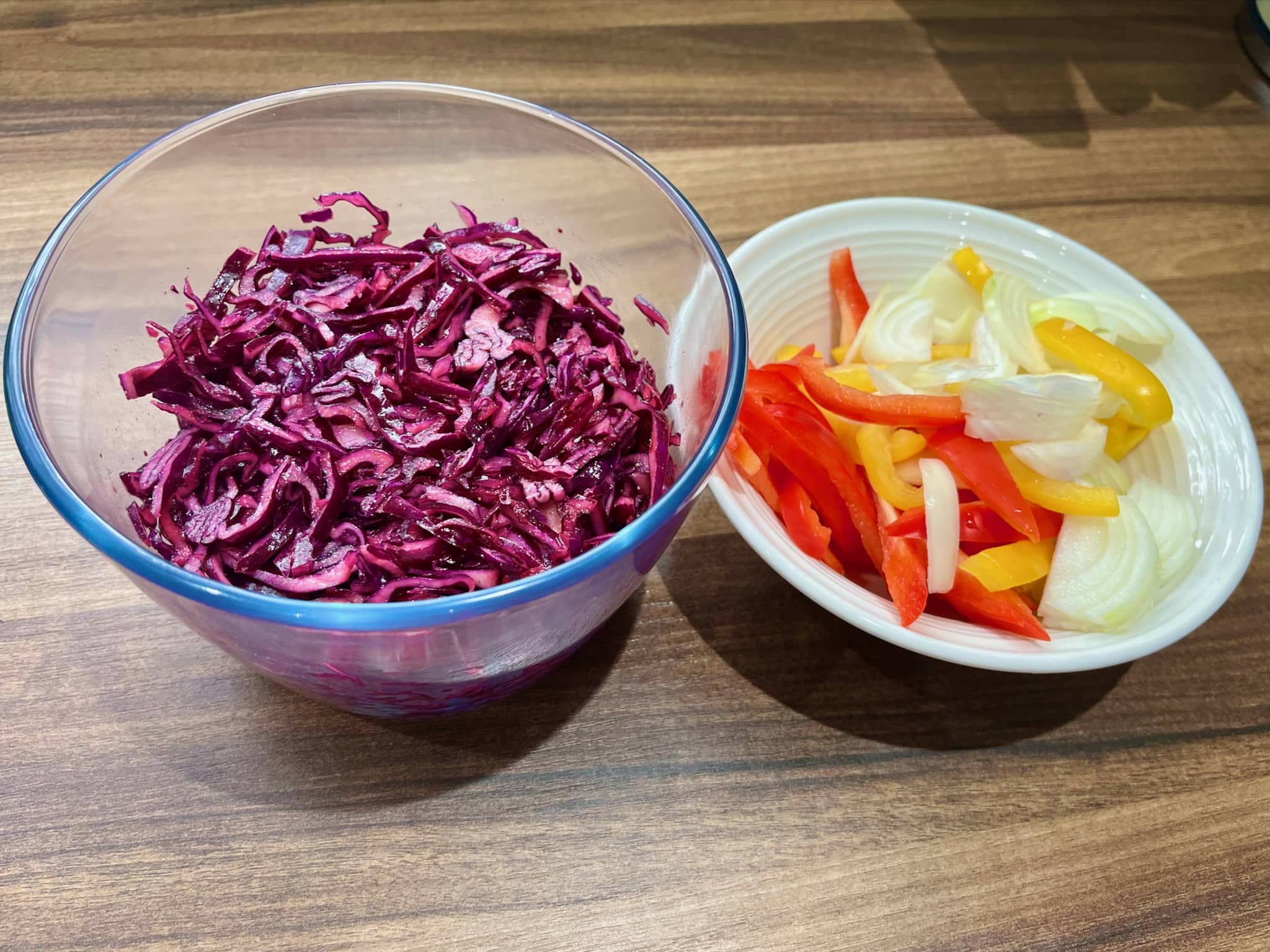 Red cabbage well mixed with vegetables in a bowl on the side
