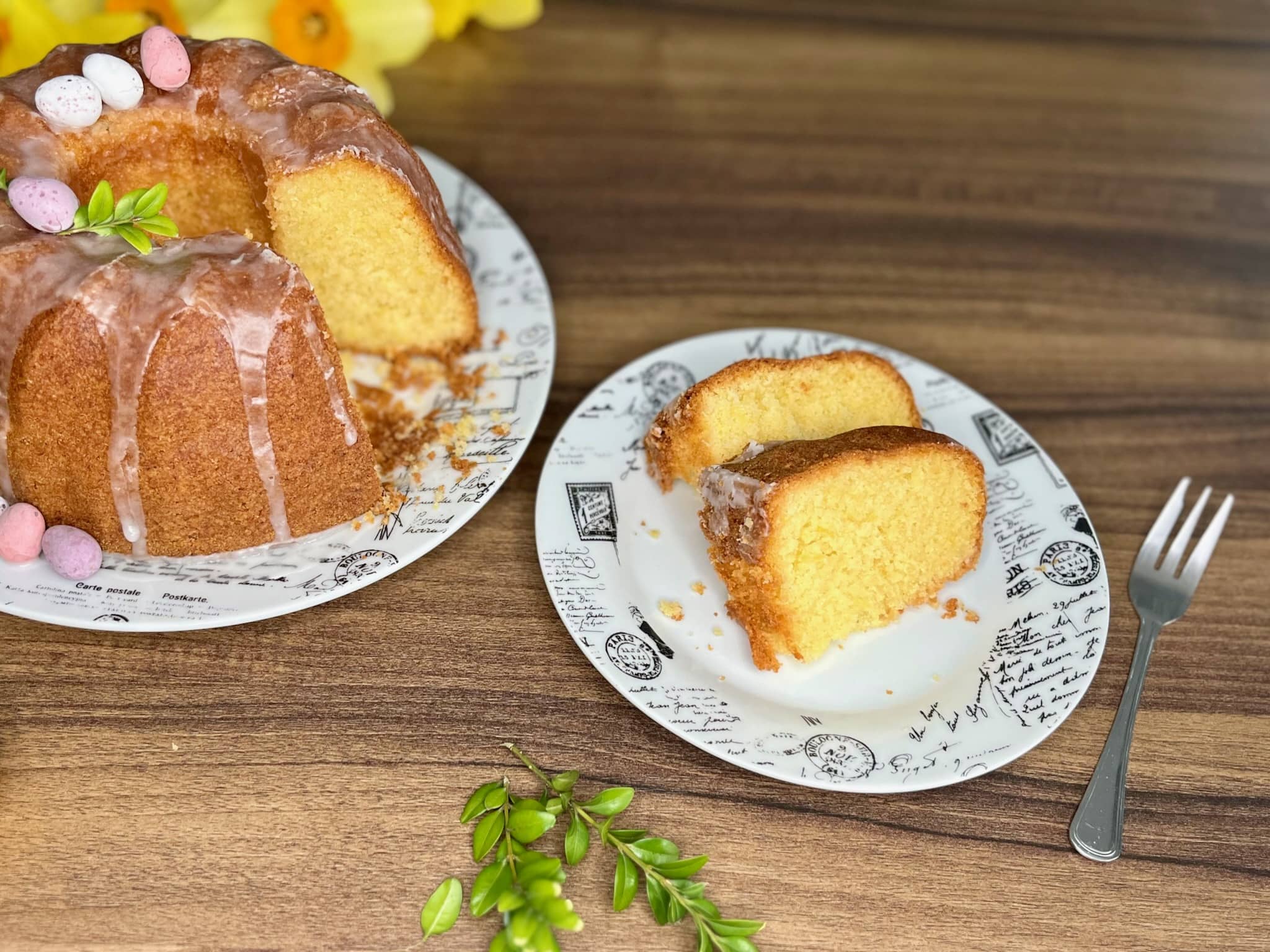 Easter Lemon Bundt Cake on a plate with two pieces cut and served on a separate plate
