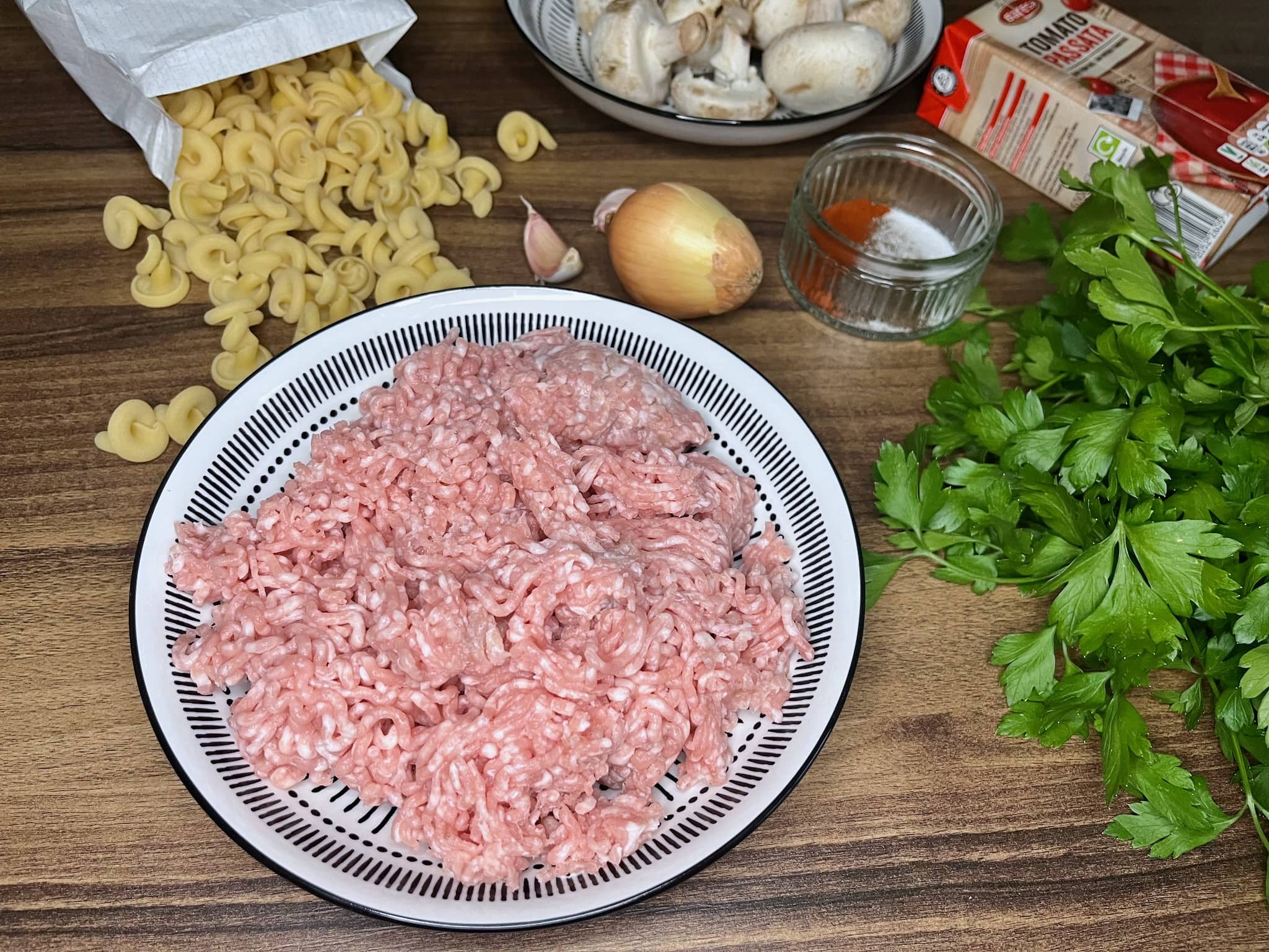 All the ingredients on the tabletop ready to make Pork and Mushrooms Pasta
