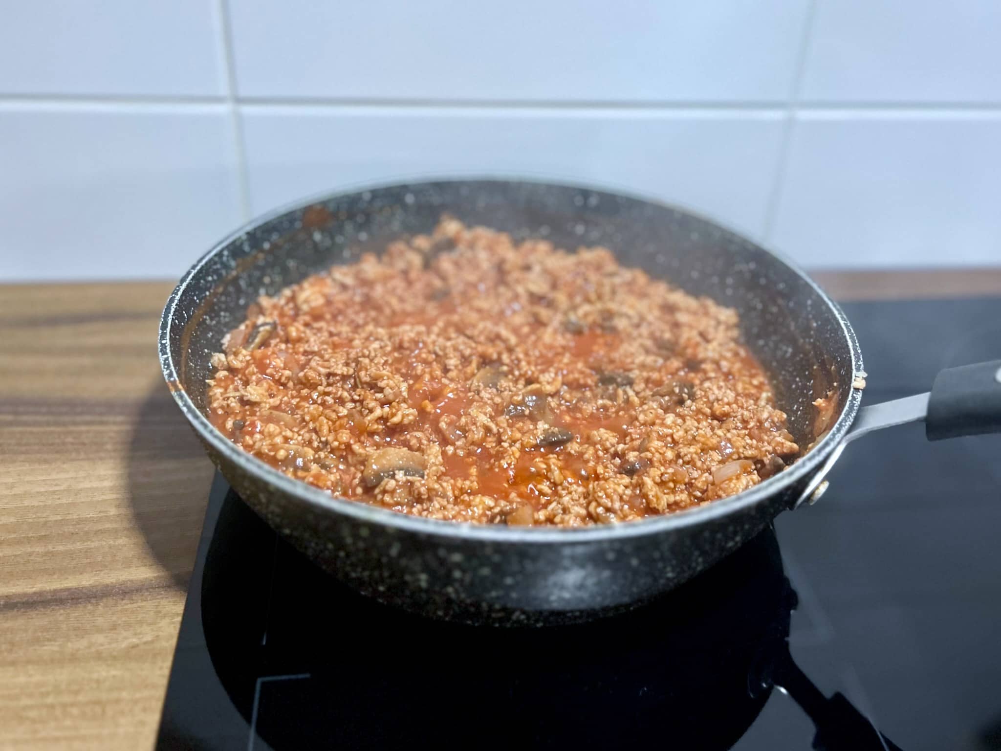 Minced pork and mushrooms with tomato passata in a pan