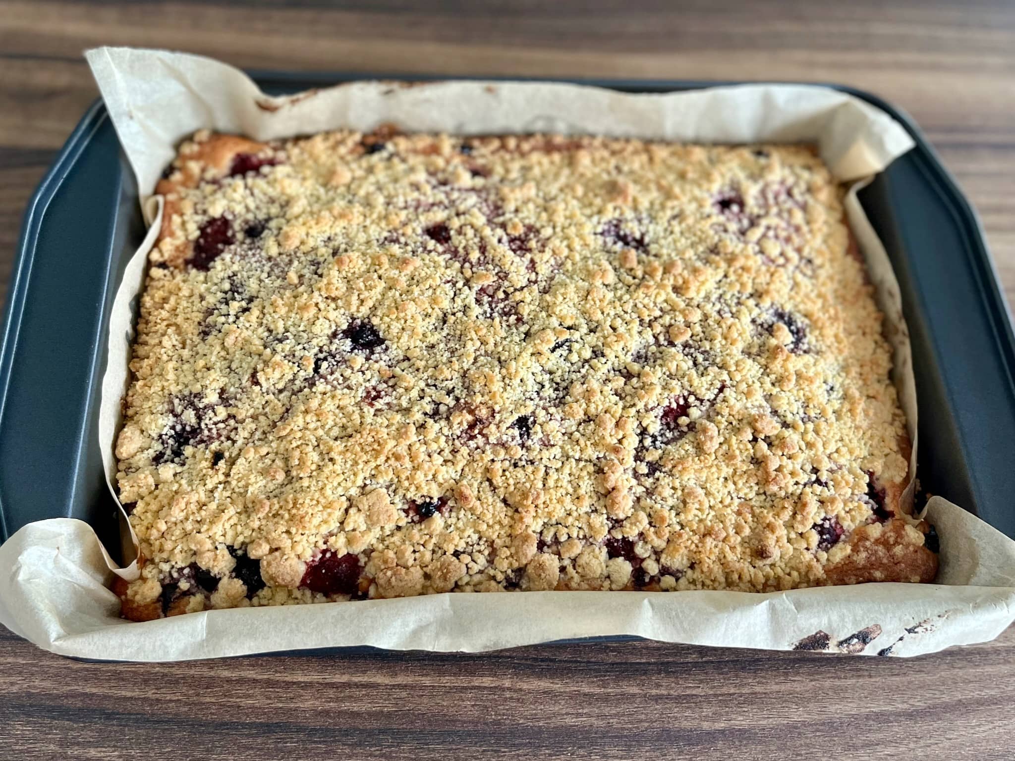 A beautifully baked Summer Berry Crumble Cake, straight from the oven