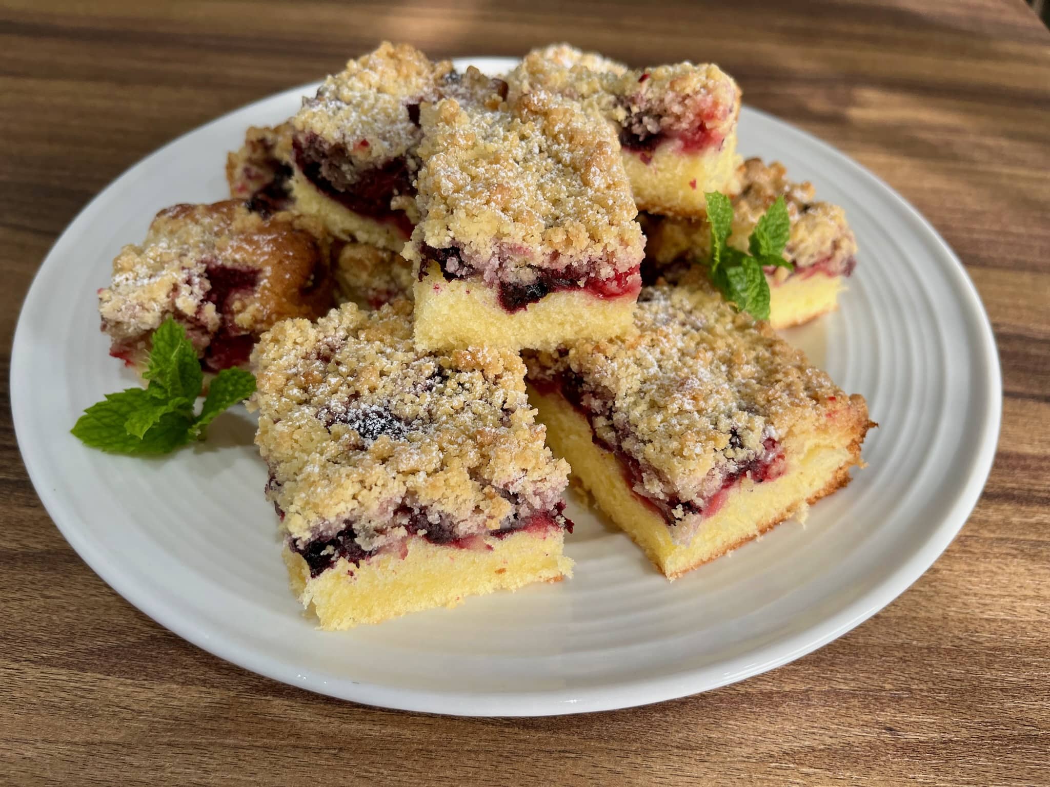 A plate of freshly sliced Summer Berry Crumble Cake