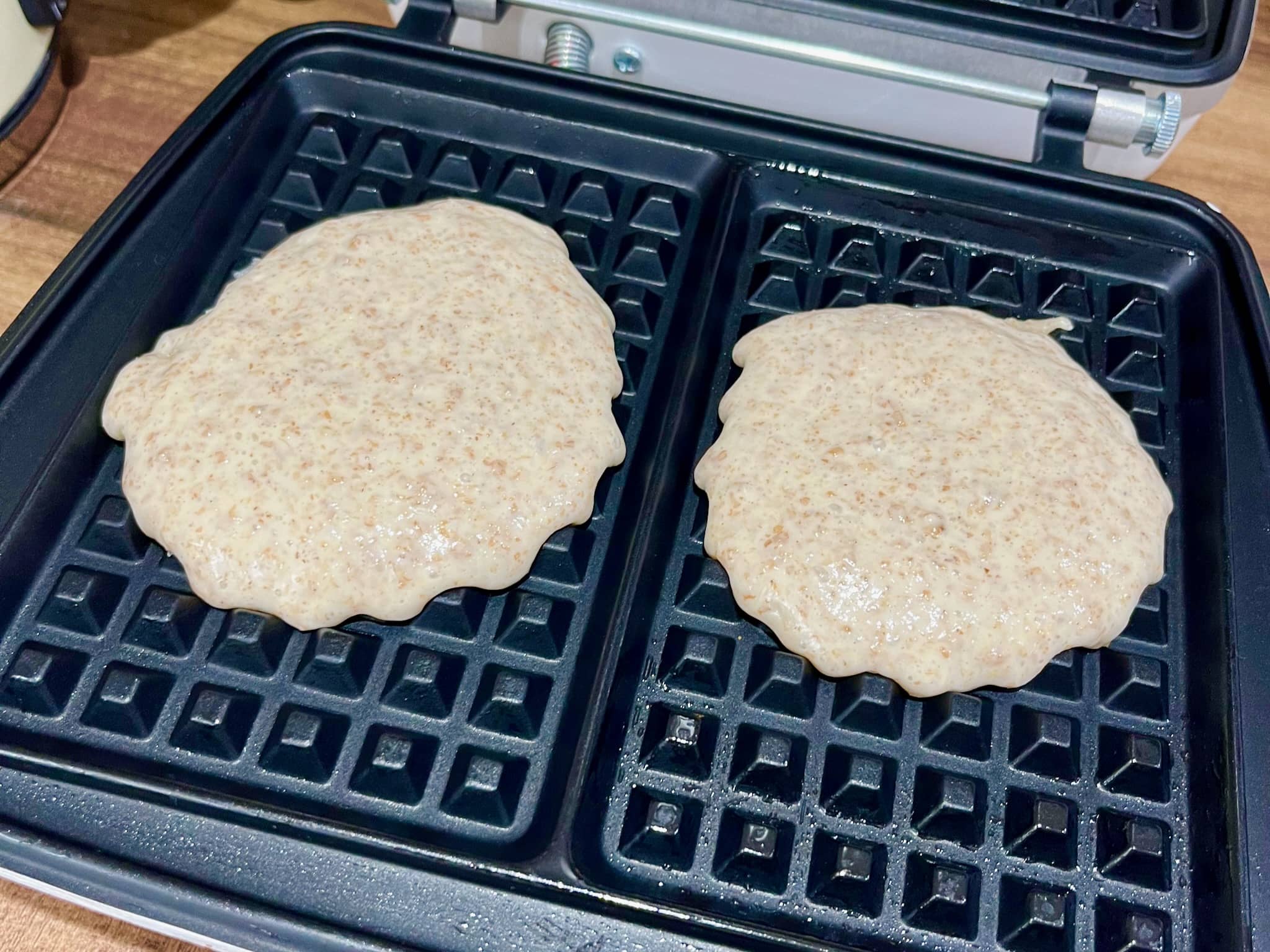 Waffles batter placed in waffle iron