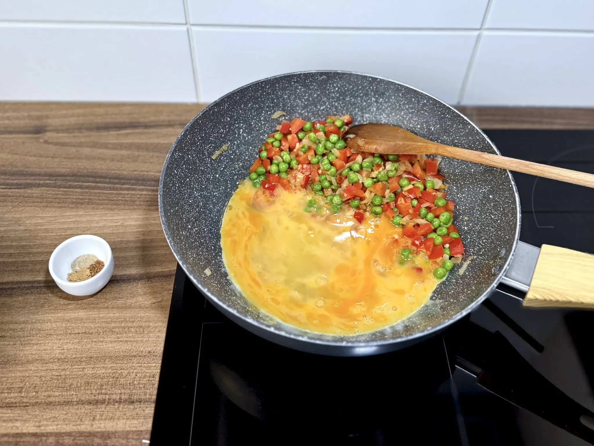 Veggies moved to the side and eggs added to the other side of the pan