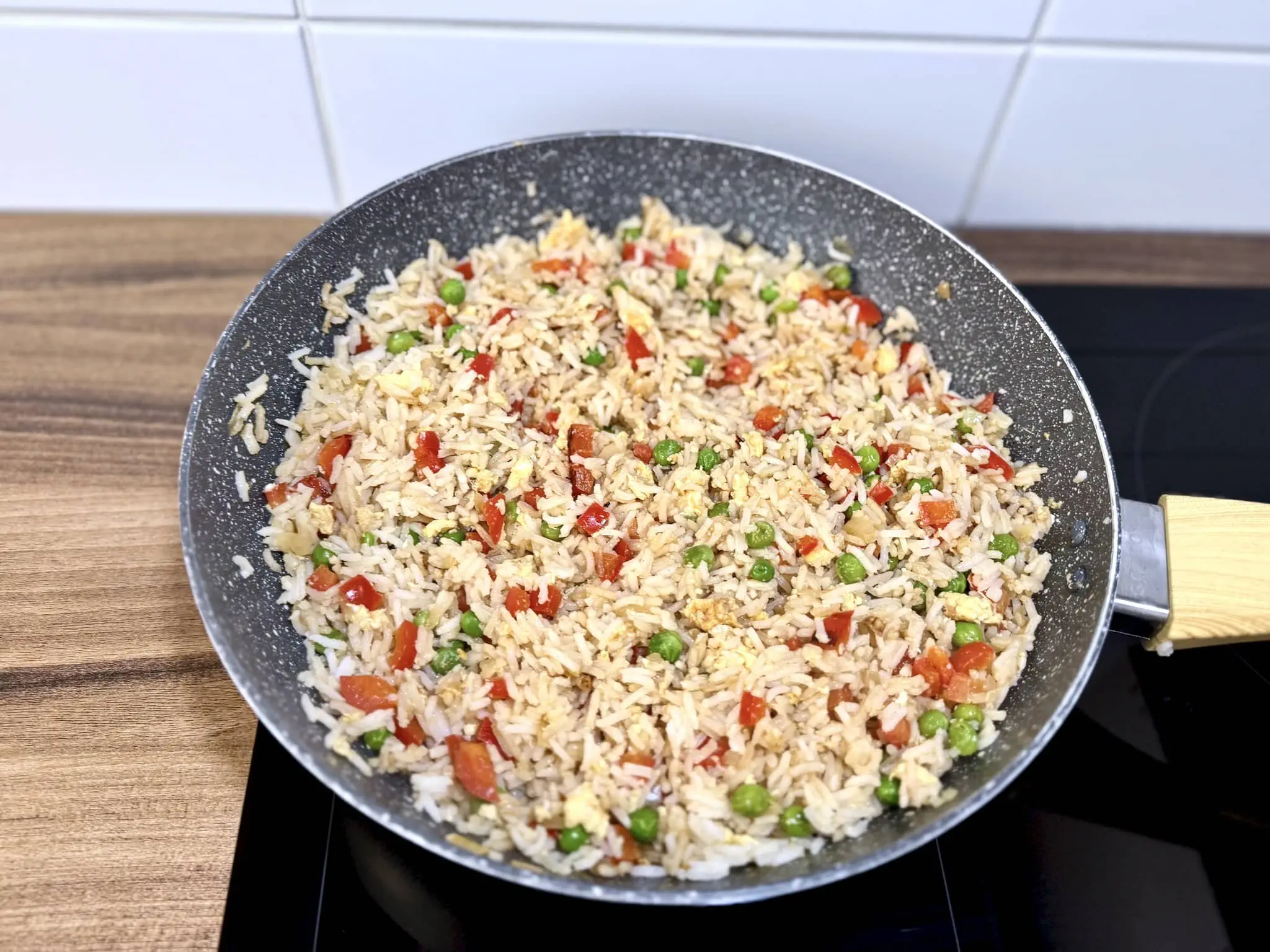 Eggs, veggies, and rice nicely mixed in the pan