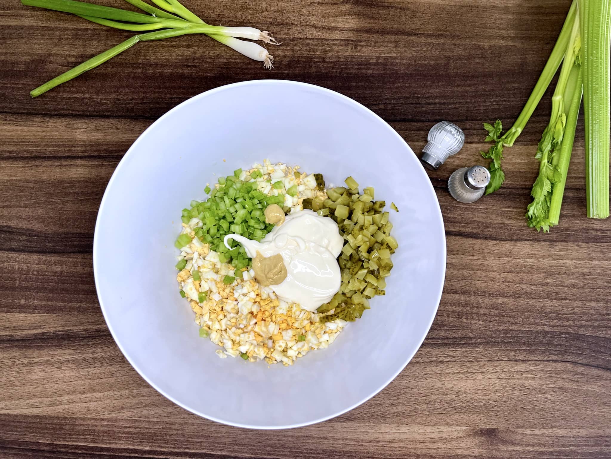 All ingredients in a mixing bowl ready to combine into Egg Mayo with Gherkins Sandwich Filling
