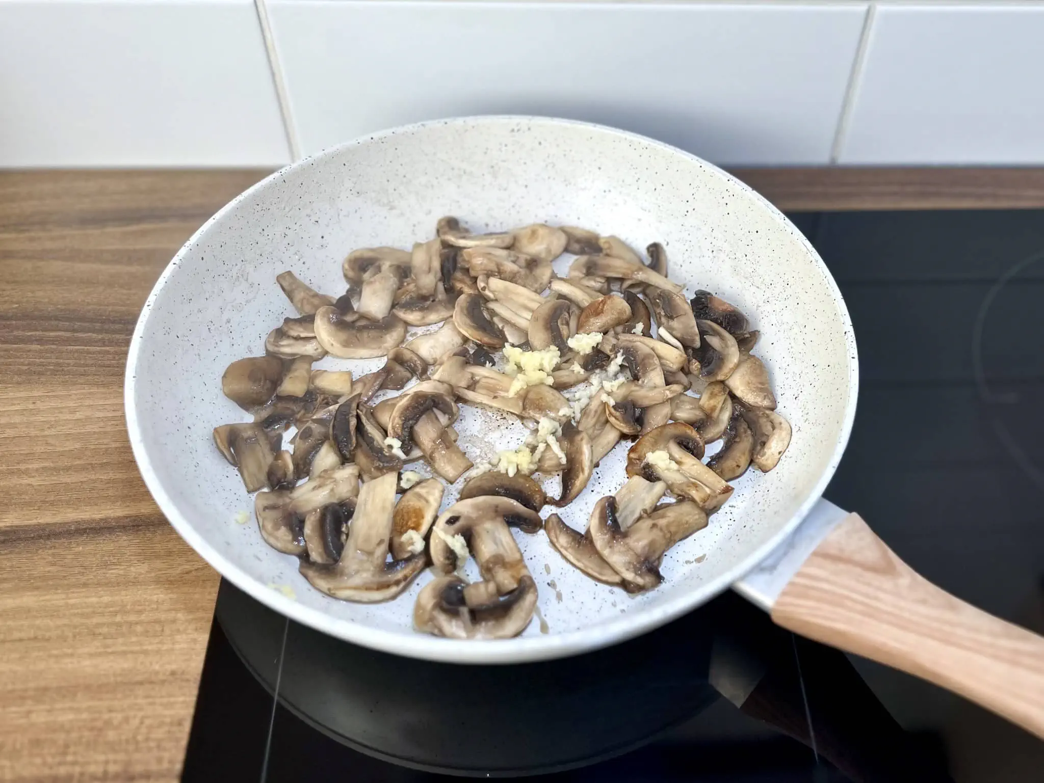 Perfectly fried mushrooms in a pan with added garlic and spices