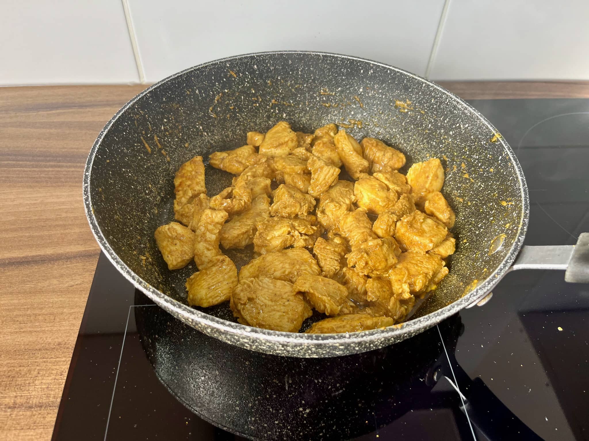 Cooked marinated chicken in a frying pan
